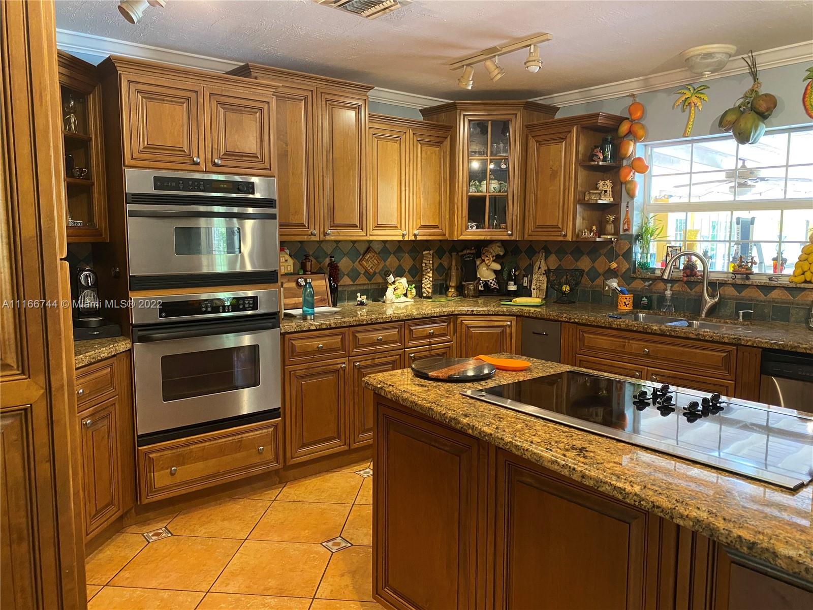 Historic Plantation single family on a builder's acre. Private lot surrounded by lush landscaping with different fruit trees and an oversized pool with a diving board. Large covered porch 20X40 with outside custom-built brick grill. This home offers 5 large bedrooms 4 full baths and 2 separate wings. Open kitchen with granite countertops and stainless steel appliances. The home was remodeled in 2002 and the tile roof was replaced in 2007. Large stamped concrete circular driveway with plenty of space to park cars.