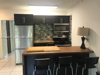 The perfect apartment: Updated 1 bedroom condo with assigned parking, 2 blocks to the ocean in sought after south of fifth street neighborhood! Pretty apartment with impact windows, custom designed open kitchen with island, butcher block countertops, stainless steel appliances including gas stove and glass tile backsplash, updated bath with glass shower doors, tile floors throughout, great closet space and furnishings included. Adorable quiet building with on-site laundry, just completed the 50 year recertification and has a new roof. Great month to month tenant looking to sign a long term lease if Buyer is interested. Low maintenance fees, assigned parking, and in the perfect location- amazing!