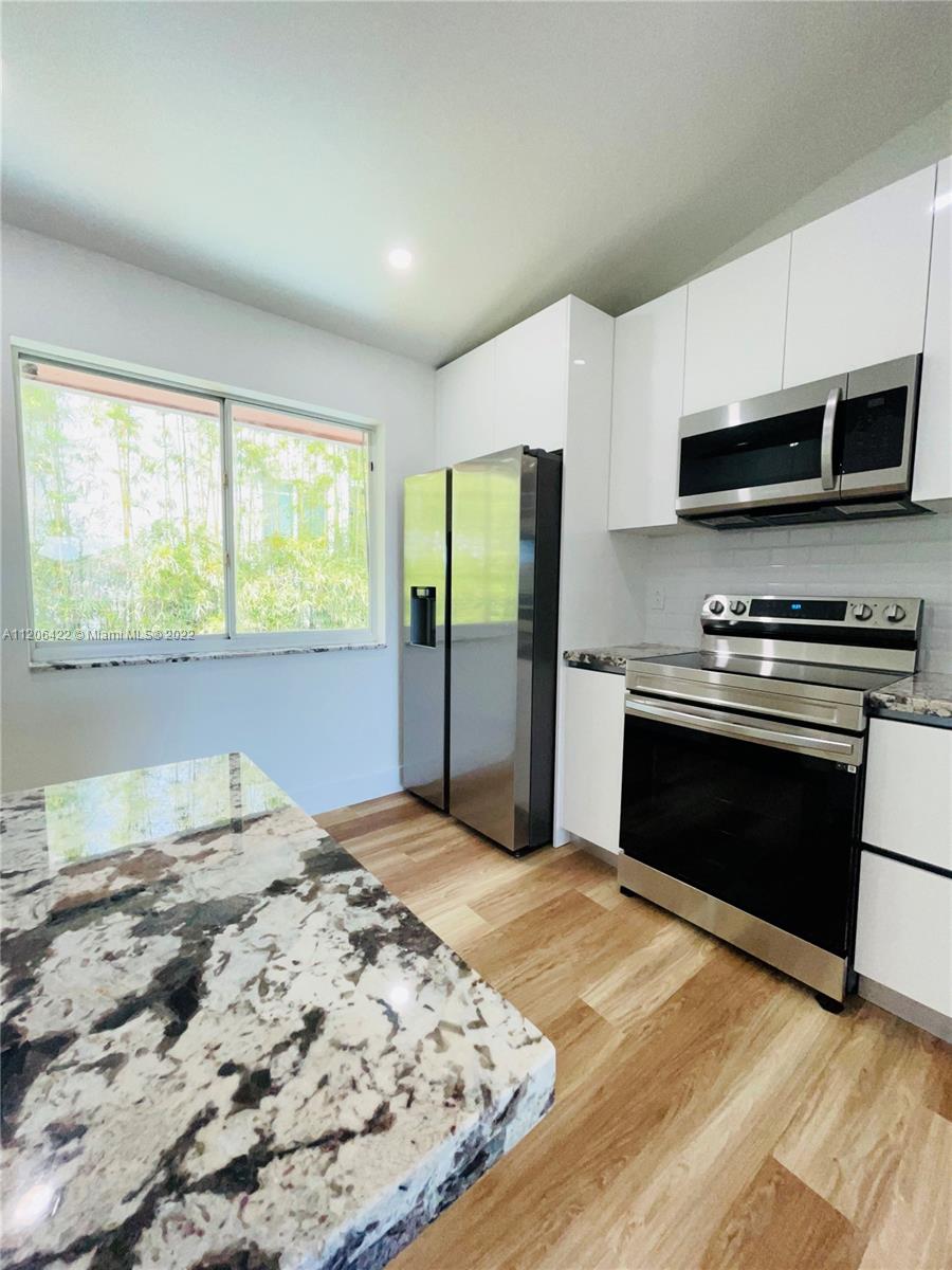 Situated next to scenic downtown Doral. This tastefully renovated 2/2 is ready for its next home owner! Be the first to enjoy it! New Appliances include New A/C, Wi-Fi enabled Samsung Stove, Samsung refrigerator, Microwave, Google thermostat, . Gorgeous countertops and custom soft close cabinetry. Recessed lighting throughout, Bathrooms fitted with luminating Mirrors, black Allen+Roth fixtures. New vinyl flooring installed to compliment the 10ft vaulted ceiling. Spacious Laundry room with stackable washer and dryer. Newly installed window shades and Black out window shades in bedrooms. Amenities include a community pool and tennis court. Two parking spots are also included. Low HOA of $174 a month. Please text for any additional information.