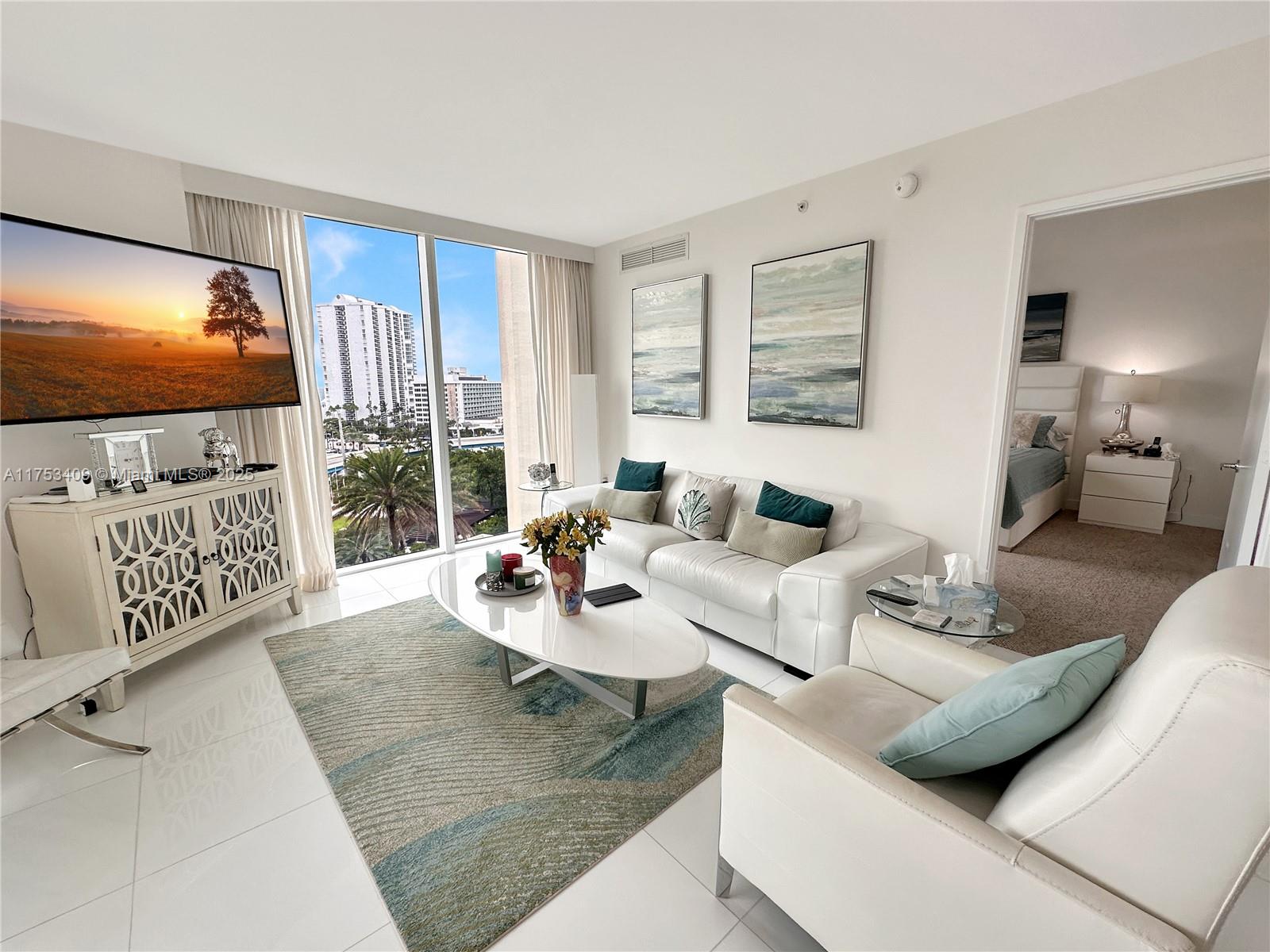 Discover luxury waterfront living in this beautifully designed 3-bedroom, 2-bath residence at St. Tropez. Floor-to-ceiling windows flood the space with natural light. The European-style kitchen boasts high-end stainless steel appliances, ideal for cooking and entertaining. The primary suite features a walk-in closet and a spa-inspired bath with a soaking tub and glass-enclosed shower. Step onto the expansive balcony to enjoy stunning city views and ocean breezes. Residents enjoy premium amenities, including a clubhouse, gym, spa, and pool with private cabanas. With 24-hour valet and security, this home offers convenience and peace of mind. Ideally located in Sunny Isles Beach, just moments from pristine beaches, shopping, and dining.