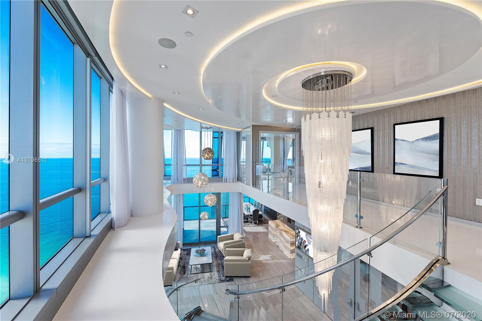 The Crown Jewel of Jade Ocean! This Corner PH has that Extra WOW Factor with a Prime Architectural & Interior Design Experience that completely transformed its 7900 SF of interior + exterior space. Residence features double height ceilings across 3 living areas, Onyx-clad bar, 5 terraces offering views of the Ocean & City, Master Suite w/ his/her bathrooms w/Bisazza mosaic tile & his/hers walk-in closets, 4 guest suites, 6.5 bathrooms, Crestron technology, 2 storage units & 3 VIP assigned parking spaces. Jade Ocean offers fully staffed amenities such as beach service, cafe, sunrise & sunset pools, wellness & fitness center, kid’s playroom, business center & in-home touch screen that allows residents to request concierge, valet, dining & spa services.