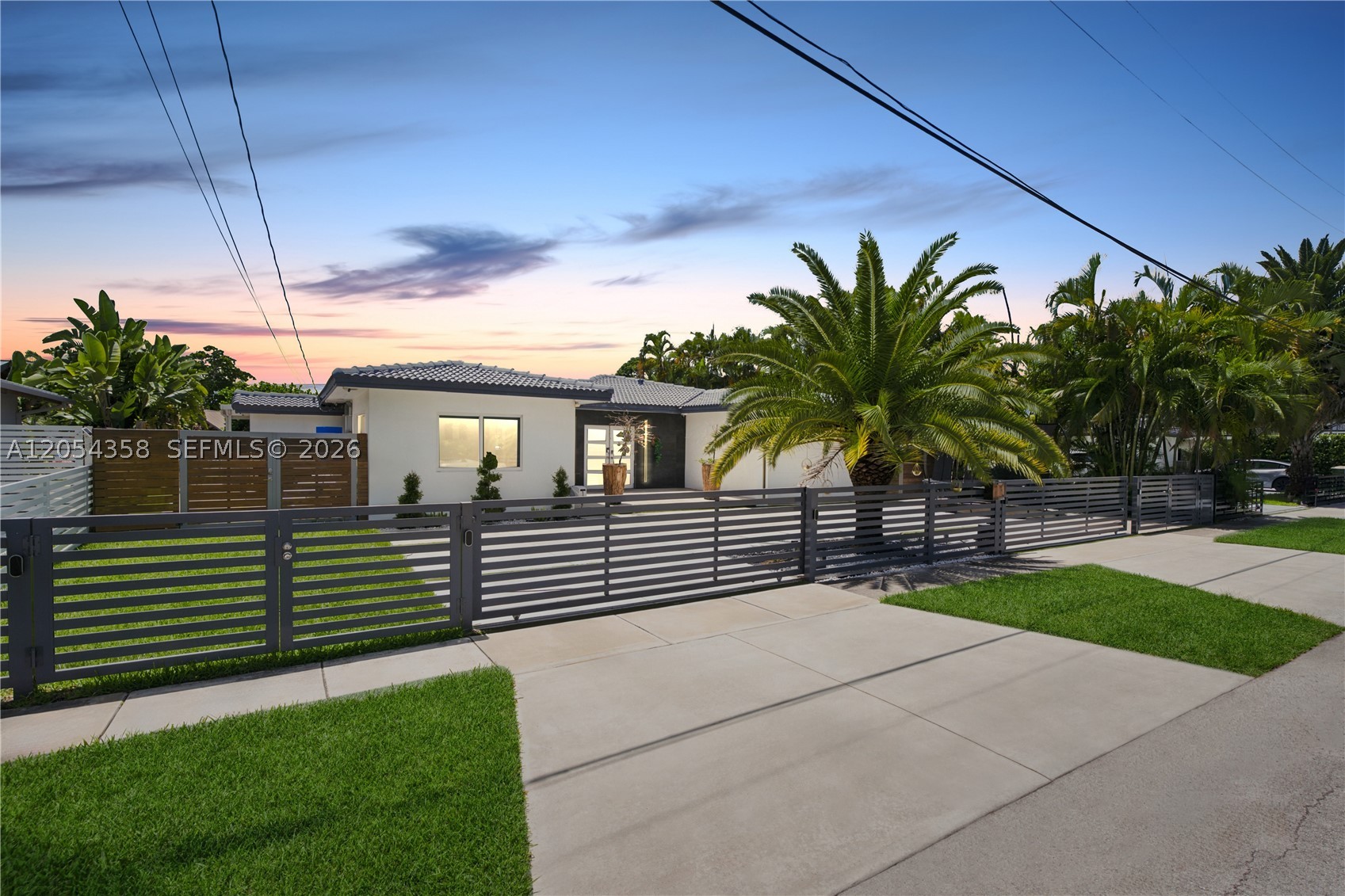 Experience beautifully remodeled waterfront living in prestigious gated Keystone Point! This 3 bedroom,3 bath home offers 75 ft of waterfront with no fixed bridges and direct bay access, a true boater’s paradise. Thoughtfully updated throughout, the home features a new kitchen, updated bathrooms, impact windows and doors, and a brand new concrete driveway with dual approaches. The open concept living room is flooded with natural light through floor-to-ceiling windows overlooking the pool and water. The spacious primary suite also overlooks the water with floor-to-ceiling windows framing beautiful sunset views, plus a large walk-in closet and a luxurious bath with dual vanities, a soaking tub, and separate shower. Outside, enjoy a covered patio, outdoor kitchen, and an expansive backyard with room for a play area or future enhancements. One full bath serves as a convenient cabana bath. Recently updated dock and 35,000 pound boat lift completes the waterfront dream. The garage is currently configured as an Air-conditioned gym with excellent functional space. Gated entry for added security!  Ideally located just minutes from Bal Harbour, the beach, Top-Rated Schools, Whole Foods, shopping, dining, and with easy I-95 access, this move-in ready waterfront home offers the very best of the South Florida lifestyle.