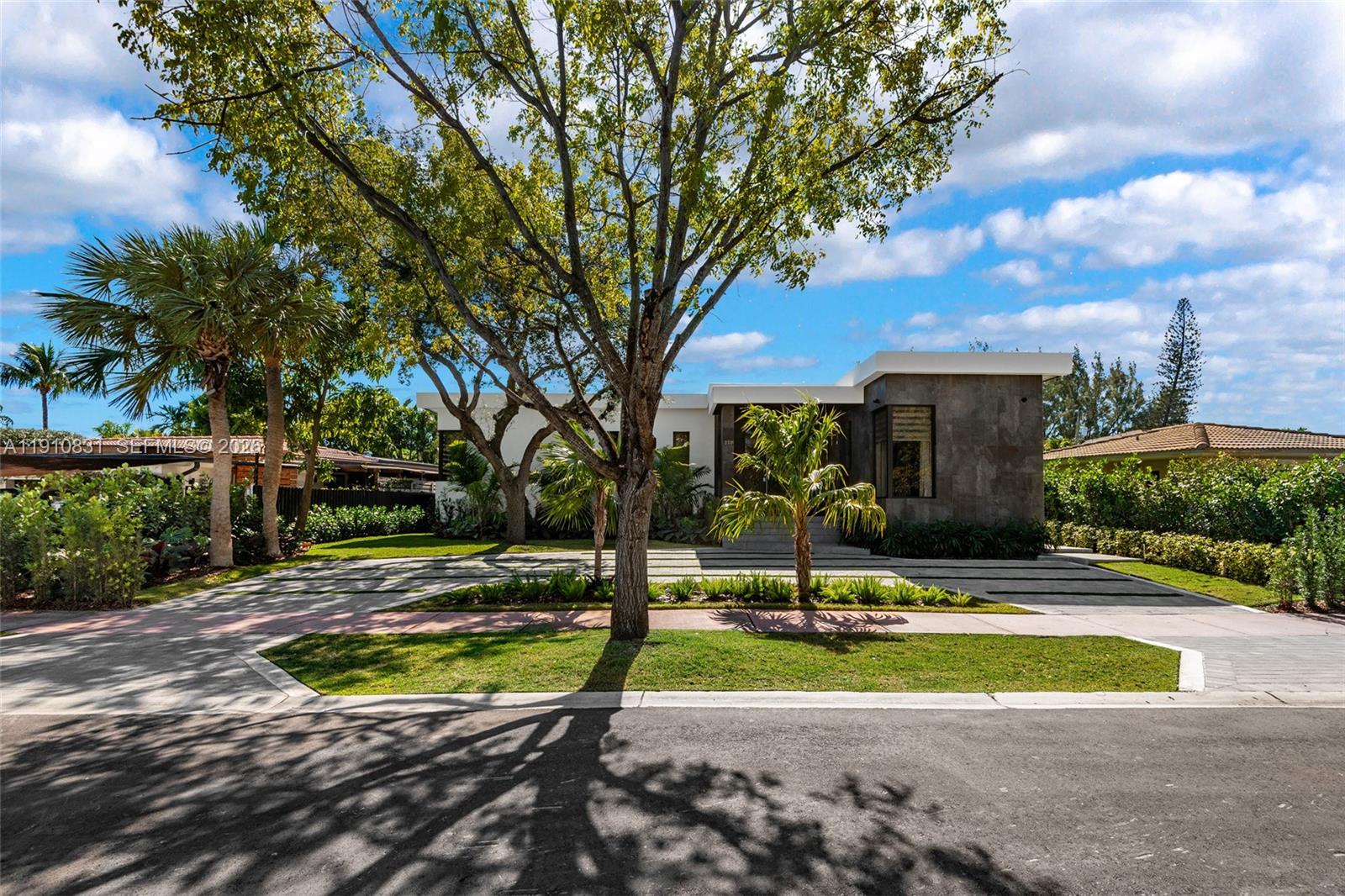 Stunning 3,164 sq ft modern 4-bedroom, 4-bath smart home in the Normandy Shores gated community, featuring top-of-the-line appliances, Italian porcelain floors and walls, granite countertops with an integrated sink, and sleek custom cabinetry. Enjoy smart wiring throughout, which includes a built-in sound system, smart projector, security cameras, and more. Additional highlights include custom walk-in closets, high-end cabinetry, Italian glossy frameless doors with aluminum casings, a high-efficiency A/C system, and premium electrical and plumbing fixtures. Located within walking distance of the Normandy Shores Golf Course, every detail has been thoughtfully designed for those who value quality and innovation.