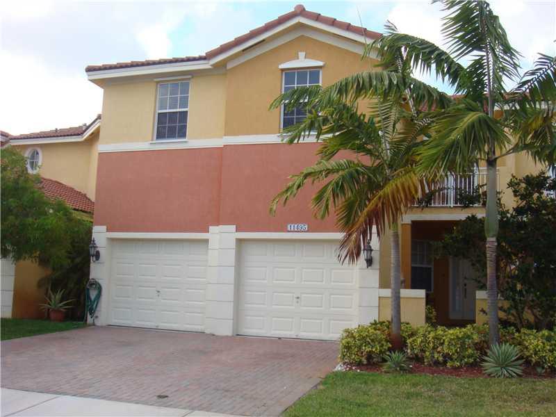 LARGEST Townhouse unit in Doral.  3/2-1/2 plus loft open to below.  Furniture is optional(may be negotiated).  2 car garage w/tile and a/c maybe used as an office or additional room, and patio.  Located in gated community. Walking distance to A+ schools,  parks, access to Island at Doral Clubhouse, pool, jacuzzi, gym, tennis, party room and more.  Close to Turnpike, 826 Palmetto & 836 Dolphin Expwy. Easy to Show. Call LA.