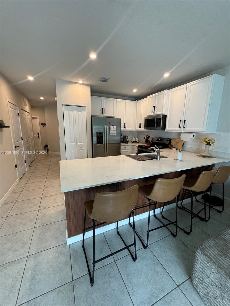 Remodeled new-construction 2023 villa featuring 3 bedrooms and 3 full bathrooms. Functional layout with 1 bedroom and 1 full bathroom on the first floor. Property includes impact windows, in-unit washer and dryer, and 2 assigned parking spaces directly in front, plus visitor parking. Pets welcome. Conveniently located near Robert Is Here, the Turnpike, Outlet Mall, and the new Publix.