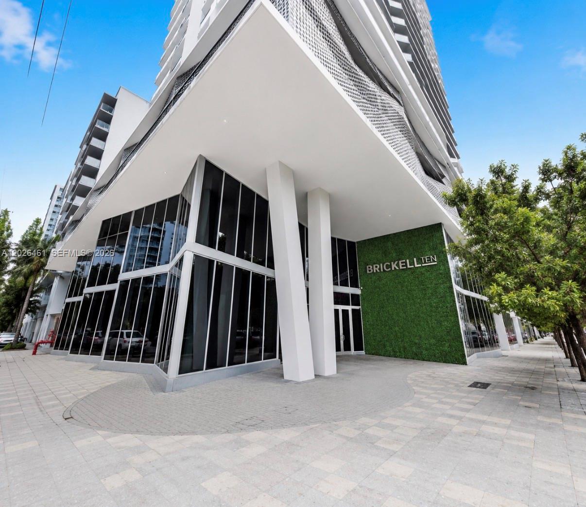 Experience elevated urban living at Brickell Ten, a desirable boutique building perfectly positioned in the heart of Miami’s vibrant financial district while offering easy access in and out of Brickell. This highly sought-after corner residence, one of the larger 2-bedroom models in the building, features an additional half bath and has been professionally designed and furnished for a true turnkey experience. The split floor plan offers both privacy and functionality, while the expansive wrap-around terrace seamlessly blends indoor and outdoor living. Thoughtfully upgraded throughout with modern porcelain floors, custom doors and casings, Lutron lighting, electric blinds and curtains, custom closets, a new washer and dryer, and a designer kitchen island with waterfall countertop, this residence exudes contemporary elegance. Includes one assigned garage parking space. Brickell Ten offers exceptional resort-style amenities across the fifth floor and rooftop levels, including a spectacular 1,600-square-foot pool with skyline views, indoor/outdoor social club , billiards room, business center, rooftop BBQ area, children’s playroom, state-of-the-art sky-view gym, outdoor bar, reflecting pool, secluded spa, and sunset terrace. Ideally located  just steps from Brickell City Centre, Mary Brickell Village, Publix, Metrorail, Metro-mover, and the Brickell Bay waterfront. Luxury, convenience, and lifestyle come together perfectly in this exceptional residence.