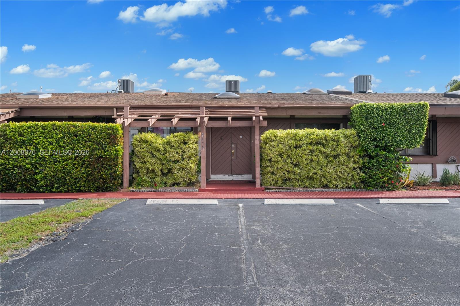 Spacious and beautifully maintained 2-bedroom, 2-bath villa offering 1,688 sq ft of living space with a desirable split floor plan. Enjoy your own private yard and atrium, perfect for relaxing or entertaining. Conveniently located just minutes from major shopping centers including Walmart, Publix, Walgreens, CVS, and more. Only 20 minutes to Fort Lauderdale Airport and a quick 5-minute drive to the beach and Three Island Kids Park. This home features two dedicated parking spaces right at your doorstep, a brand new refrigerator, and in-unit washer and dryer for your convenience. The community offers resort-style amenities including a swimming pool, tennis court, and sauna. Cable and internet are included in the maintenance fee. Leasing is permitted in the first year. Easy to show