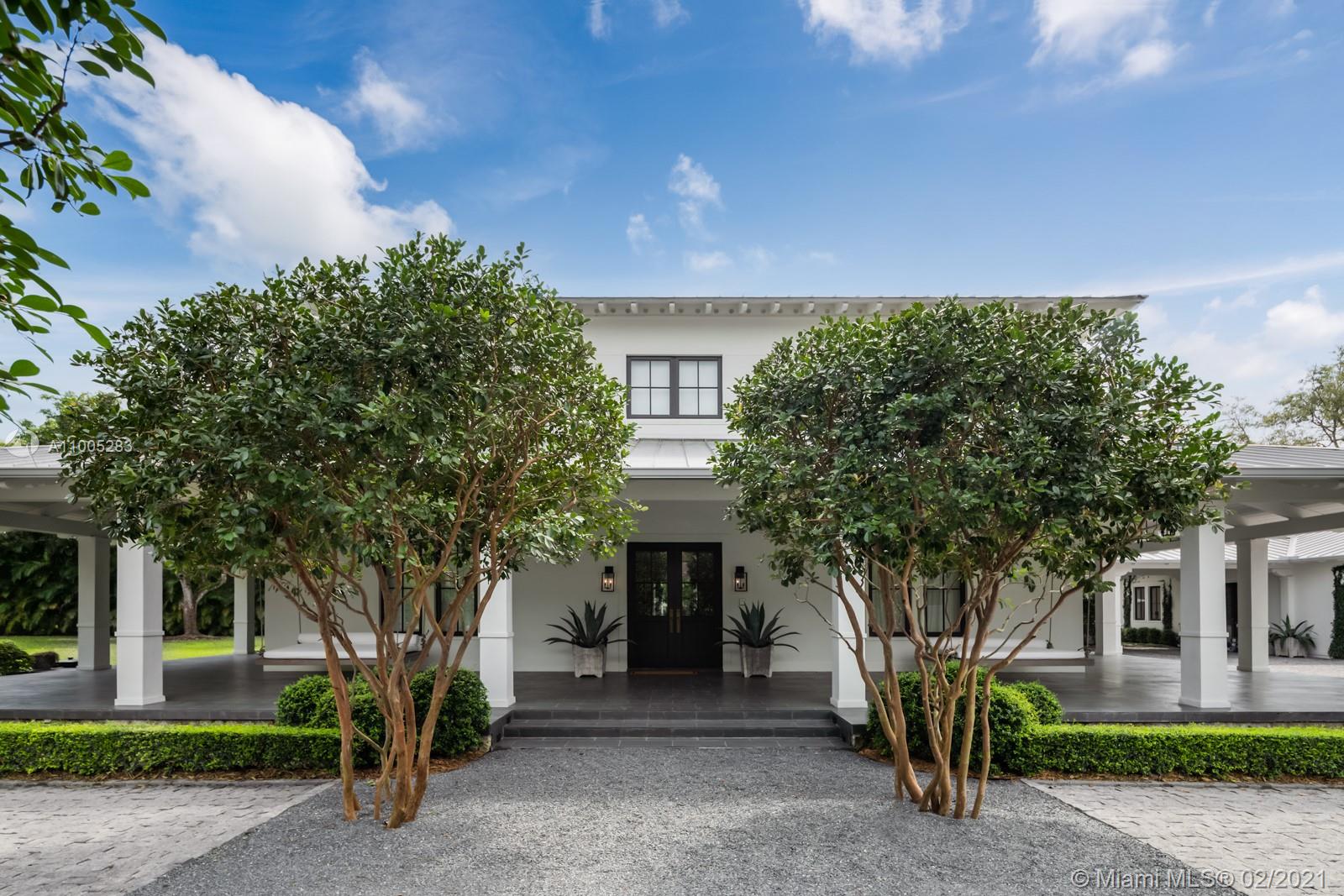 Flawlessly curated, park-like North Pinecrest gated estate embodies best of Modern Farmhouse & Key West vernaculars. Taken down to studs/fully updated in 2019 by visionary interior designer/owner; all-NEW electric/plumbing, CGI windows/doors & white oak floors. Sophisticated restraint, neutral palette & classic lines impart a timeless vibe. Welcoming entry; formal Living & Dining rms, flowing Family & informal Dining rms; Miele-appointed Kitchen; Play rm; Mud rm. Upstairs: en-suite Bdrms; Master w/Office, gracious Bath & Walk-in; Wet Bar; Laundry rm. Amazing 360° wrap-around Porch adds 3,250+/- SF of outdoor covered living/entertaining. Detached 3.5-car garage, Laundry rm, Maid’s rm & Guest House w/Breezeway & Carport. Resort Pool/Spa. Like walking thru an Architectural Digest cover story!