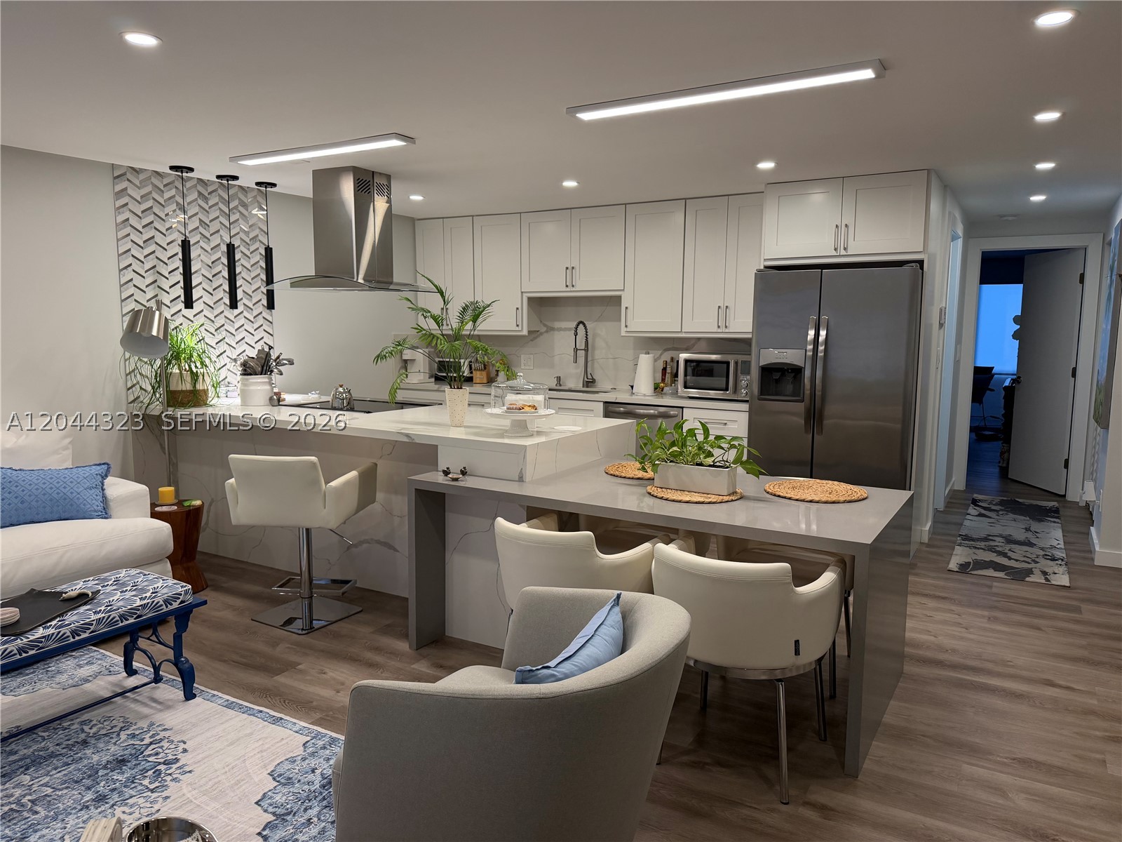 This is an impressive apartment, remodeled with all levels of details considered with an eye for design. Drop ceilings with dimmable recessed LED lighting conceal custom window treatment hardware, custom kitchen cabinetry with ample storage, pop-up island outlets, two-level bar seating, quartz countertops/backsplash, new stainless steel appliances, lineal a/c diffusers, built-in custom closets to maximize space, and tiled bathroom walls and floors. 

A new water heater was installed 8 months ago, the roof of the building is currently being replaced. No assessment feed currently. Laundry/utility room is steps away. Large individual storage space along with additional shared locked storage room for larger item like bicycles. 

55+ Wynmoor complex has many amenities to keep the residents entertained, with complex spaces for all hobbies, including a full 18 hole golf course on the property. Make an appointment today!