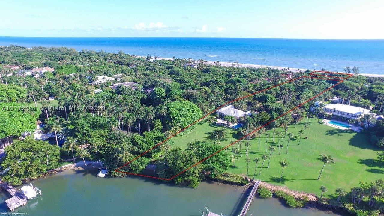 Be amazed at the tropical beauty of the 2.5+/- acre estate comprised of two deep parcels that provide ocean access with 131+/- feet of private beachfront and just enough riverfront to enjoy spectacular Florida sunsets reflecting off the Intracoastal.  Its charming courtyard entry invites visitors in with a warm welcome. The classic Bermuda-style main house includes 3-bedrooms, 5.5-baths exuding understated elegance that is found throughout Jupiter Island. Treasured cypress walls and terracotta tile floors are featured in the main living areas with parquet flooring in the formal dining room and bedrooms. Step outside to the delightful covered lanai and terrace with pool nearby, all overlooking the vast lawn and riverfront.  The property also includes a very private separate guesthouse.