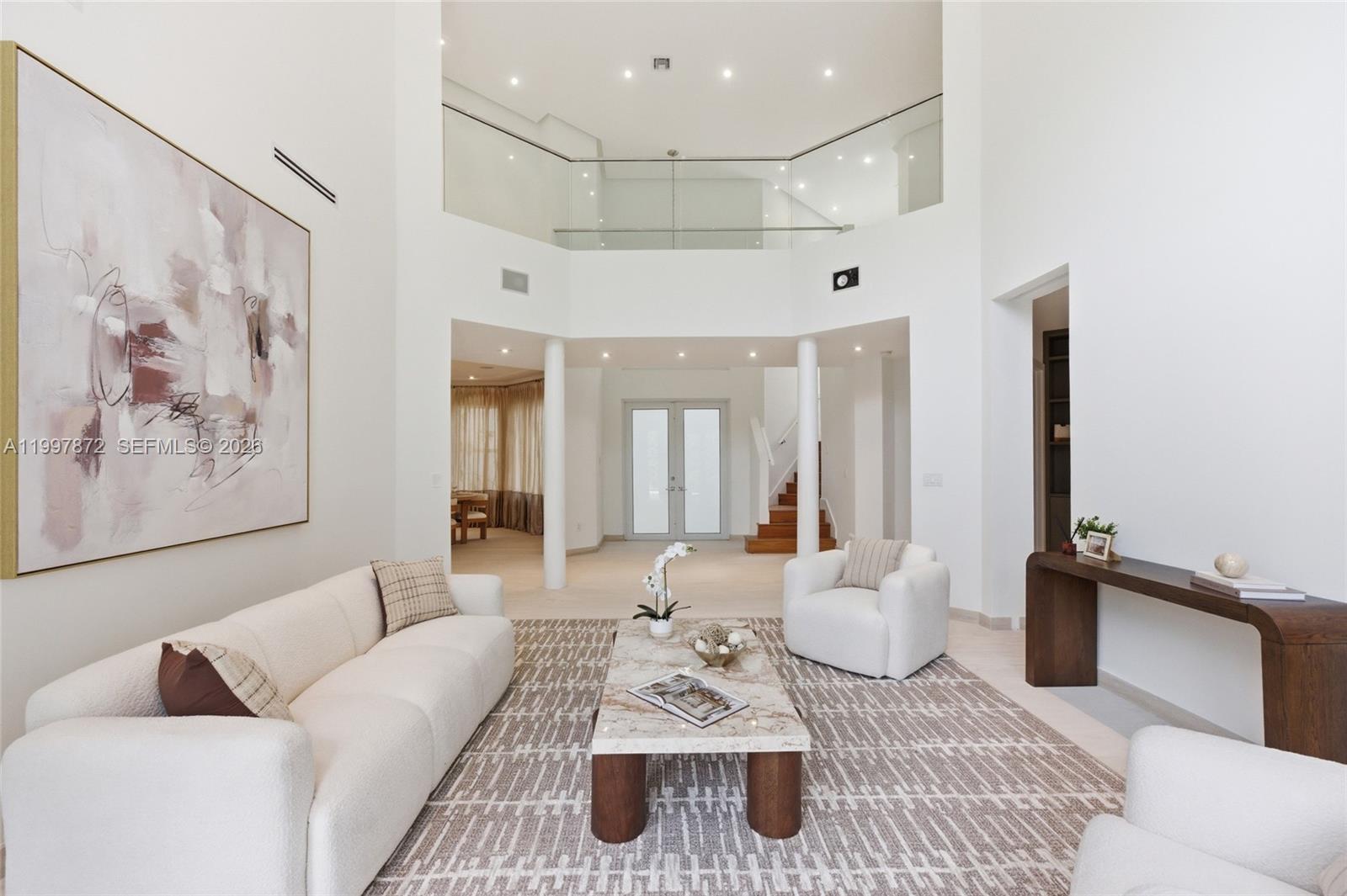 Introducing this one-of-a-kind property in the prestigious gated community of Country Club Estates, Aventura. This extraordinary residence stands out as one of the largest in the area, sitting on an expansive lot of nearly 10,000 sqft and offering over 5,000 sqft of living space. The home features 5 spacious bedrooms, each with its own ensuite bathroom, plus a total of 6.5 baths. Elegant limestone floors adorn the lower level, while warm wood flooring enhances the second floor. The stunning exterior includes a large driveway, a covered two-car garage, and a beautifully designed patio with a covered terrace, pool, and jacuzzi—perfect for entertaining. Properties of this size and caliber are truly rare in Aventura. Don’t miss this unmatched opportunity!