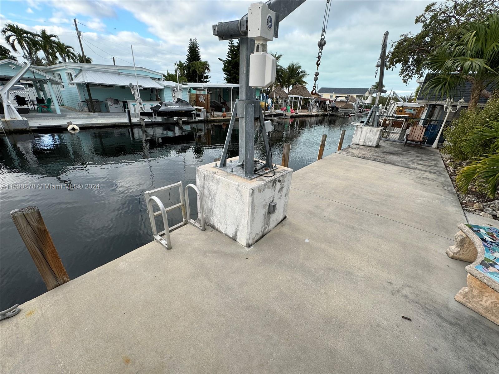 Experience waterfront paradise in Key Largo! This immaculate 2-bed, 2-bath home featuring fresh paint, new lights, fans, and a sleek bath fitter tub shower combo. Enjoy your private oasis with an updated 45-foot concrete dock, 13,000lb davits, and screened patio with serene water views. Just one canal from Tarpon Basin, perfect for fishing and dining. Ideal for a weekend getaway or year-round living. Own your slice of paradise today!