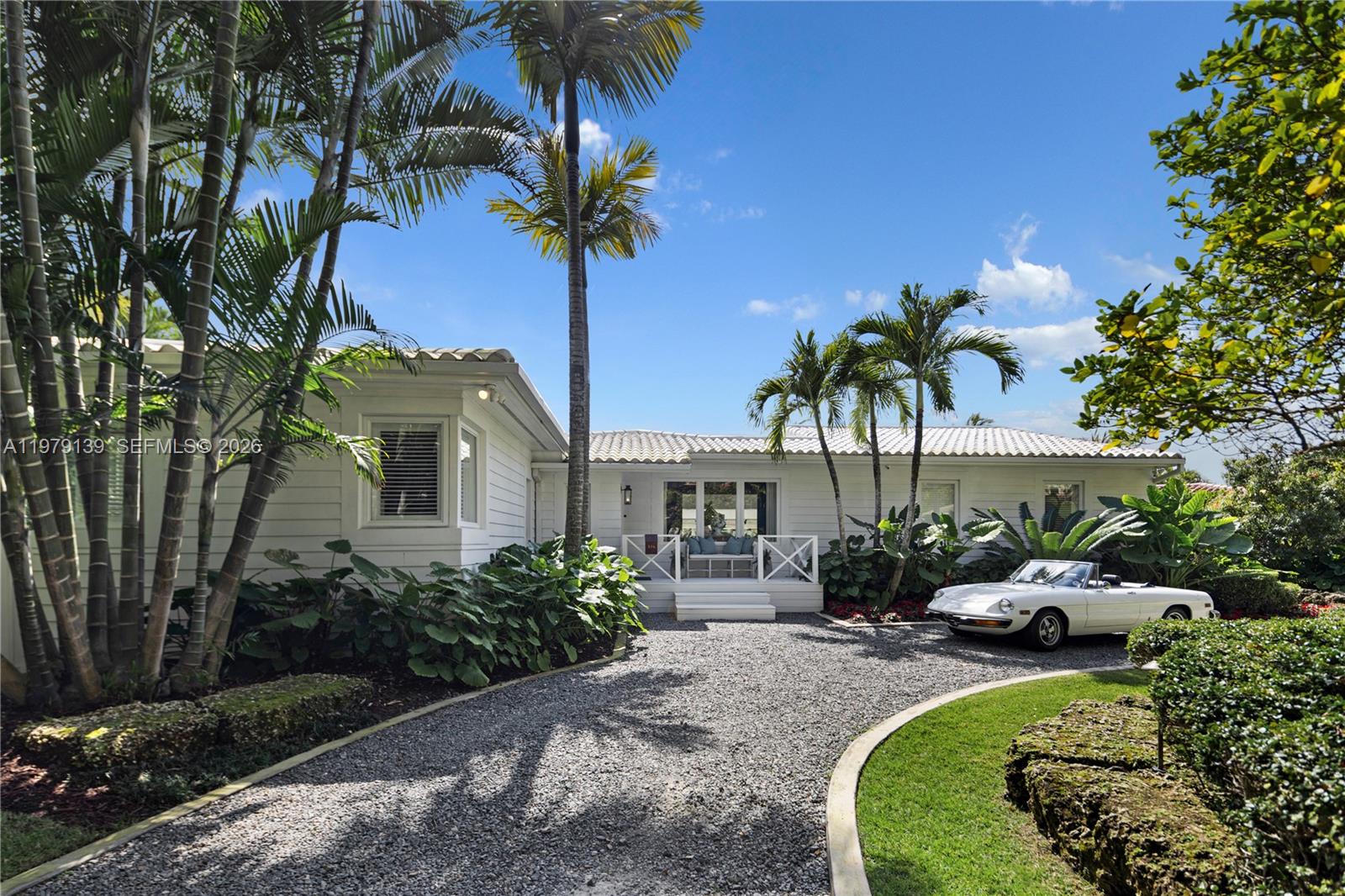 A classic Florida-style residence enjoys sweeping views across the widest bend of the canal, where tranquil water vistas and lush surroundings create a truly picturesque setting. Resting atop a natural bed of exposed coral rock along the dock, the home reflects the timeless character of South Florida’s coastal architecture, gracefully positioned along 90' of waterfront on the Coral Gables Waterway. 3 bedrooms + den and 4 bathrooms, light-filled interiors are framed by expansive picture windows that invite the outdoors in, bathing the home in natural sunlight throughout the day. Painted concrete and wood floors lend a relaxed yet sophisticated coastal aesthetic, while a thoughtfully designer-curated interior creates polished, picture-perfect living. In 2015, the residence underwent a comprehensive renovation including updated plumbing, electrical, the enclosure of the garage to enhance the home’s livable space. Roof installed within the past 3 years. For boating enthusiasts, the property features a rare grandfathered boat cutout and a dock with storage shed. This exceptional property offers a rare opportunity to experience classic Florida waterfront living with thoughtful modern updates in a serene, light-filled setting. Not located within a flood zone. As seen in LUXE Magazine.