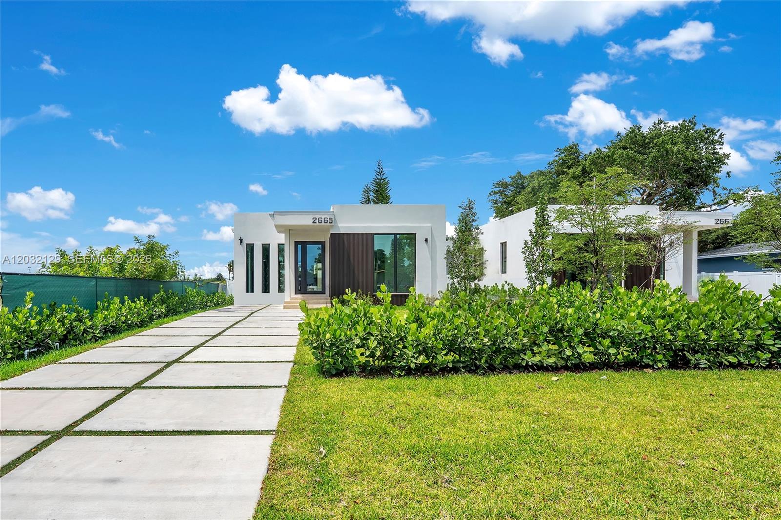 Exceptional new construction pool home on Johnson St! Thoughtfully designed with modern living in mind, this 4 bedroom, 3 bath residence showcases quality craftsmanship and premium finishes. Soaring 9-foot ceilings and an open, bright layout that creates an inviting atmosphere in every room. Built with solid concrete and concrete block construction, this home offers lasting durability and enhanced security. Beautifully designed custom kitchen is the heart of the home with abundant cabinetry, Samsung appliances, and a wine cooler—perfect for entertaining. Elegant rectified Spanish porcelain flooring flows throughout, adding sophistication and timeless appeal.  Designed for both comfort and efficiency, the home includes impact windows that maximize natural light while helping reduce heat transfer and energy costs. A state-of-the-art A/C system with a 10-year warranty ensures year-round comfort, while LED lighting, modern electrical systems, and integrated fire safety features provide added peace of mind. Designer bathrooms showcase sleek modern fixtures, high-quality plumbing, and stylish tempered glass shower enclosures with elegant finishes. Outside, enjoy a beautifully landscaped setting complete with a stunning pool and travertine deck. The property also features an automated irrigation system with rain sensors and a private well for cost-effective maintenance. Adding even more value, the home is built to the latest FEMA elevation standards!