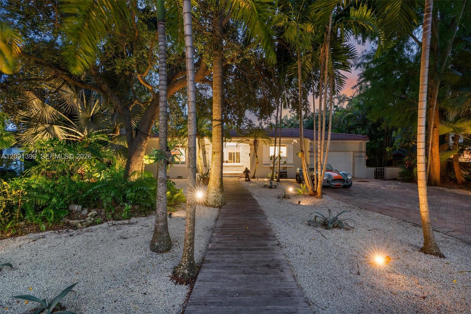 Located in highly sought-after east of Biscayne neighborhood in Miami Shores, this 3-bedroom, 3 and a half-bath residence offers 2,410 SF of living space on an 8,925 SF interior lot. The single-story floor plan features vaulted ceilings, a fireplace, French doors, built-ins, and multiple living and entertaining areas. A spacious primary suite is complemented by large secondary bedrooms and generous storage. The kitchen opens to the main living spaces and overlooks the backyard and pool area. Outside, a 20' x 40' pool, covered porch, patio, and mature landscaping create a private setting for year-round outdoor living. Additional features include a one-car garage, paver driveway, fenced yard, hurricane shutters, and updated systems and finishes completed over time. Conveniently located near Miami Shores Country Club, top schools in Miami, downtown Miami Shores, dining, shopping, and area beaches.