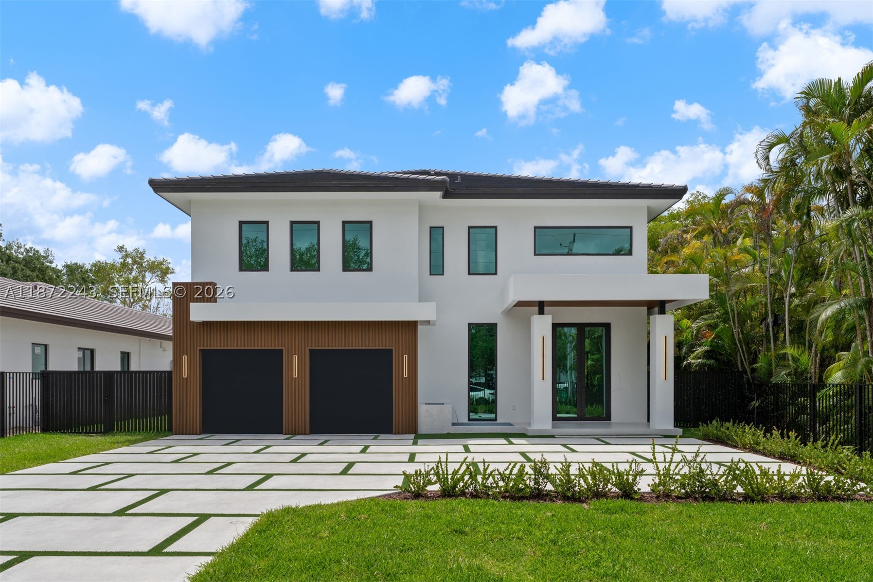 Be the first to own this brand-new construction estate, a stunning 5-bedroom, 5-bathroom modern residence set on a 20,468 Sq.Ft. lot. Designed with exceptional craftsmanship, the home features elegant porcelain tile floors, soaring ceilings, hurricane-impact construction, a sleek tube elevator, and an EV-ready 2-car garage. The gourmet kitchen is appointed with premium Thermador appliances, quartz countertops, custom cabinetry, and a spacious island. Upstairs, a versatile loft complements the luxurious primary suite with a private terrace, dual walk-in closets, and a spa-inspired bath. Expansive covered terraces overlook the pool, summer kitchen, and spacious backyard, creating the perfect setting for entertaining and enjoying South Florida's indoor-outdoor lifestyle.