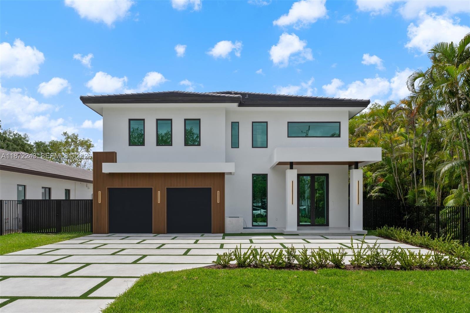 Be the first to own this brand-new construction estate, a stunning 5-bedroom, 5-bathroom modern residence set on a 20,468 Sq.Ft. lot. Designed with exceptional craftsmanship, the home features elegant porcelain tile floors, soaring ceilings, hurricane-impact construction, a sleek tube elevator, and an EV-ready 2-car garage. The gourmet kitchen is appointed with premium Thermador appliances, quartz countertops, custom cabinetry, and a spacious island. Upstairs, a versatile loft complements the luxurious primary suite with a private terrace, dual walk-in closets, and a spa-inspired bath. Expansive covered terraces overlook the pool, summer kitchen, and spacious backyard, creating the perfect setting for entertaining and enjoying South Florida's indoor-outdoor lifestyle.