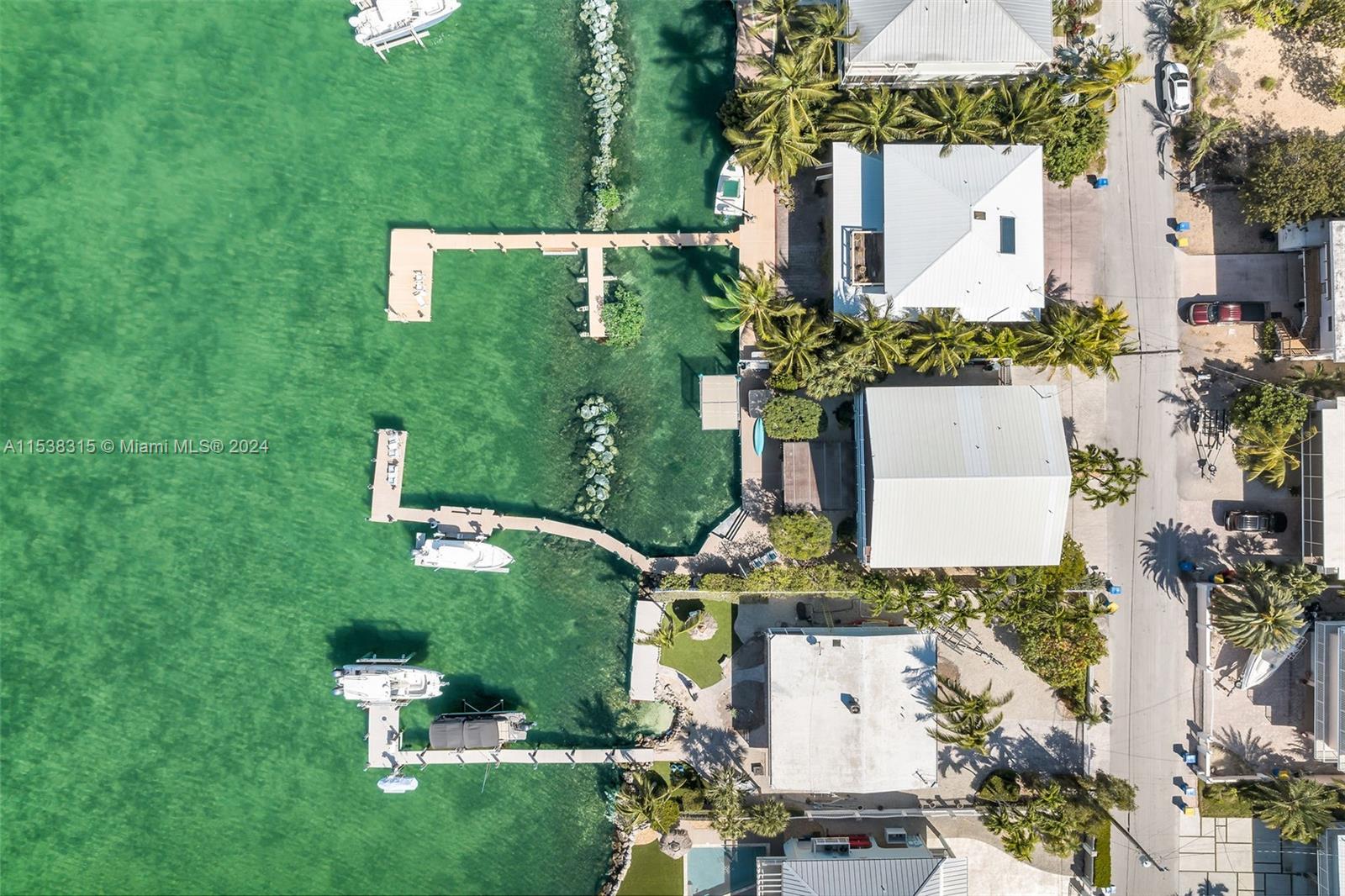 This waterfront paradise has everything you could desire! Enjoy breathtaking sunsets every evening, ample dockage, and plenty of space for family and friends to gather. This 5-bedroom, 5-bathroom home offers numerous comfortable living areas, both indoors and out, perfect for embracing the relaxed Keys lifestyle. With a small private basin featuring a concrete seawall, a 20K# boat lift, a 100'+ dock, and a lift for your skiff, there's no shortage of space for your boats. Spanning over 4,000 square feet under AC, there's plenty of room for all your loved ones. The thoughtful layout of this three-story home is designed for both comfort and functionality. 2019 25' Sea Hunt may be included in the sale. This is a boater's paradise! Don't miss the 3D video tour.