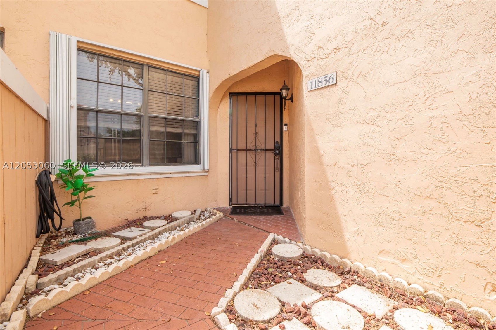 Welcome to this beautifully maintained corner residence with the convenience of first floor living with no stairs to climb! This spacious 3 bedroom, 2 bathroom home features a bright, open floor plan with a beautifully updated kitchen, stainless steel appliances, ample cabinet and counter space, and a seamless flow into the living and dining areas, creating the perfect space for everyday living and entertaining. The oversized primary suite offers generous closet space and a private ensuite bath, while two additional bedrooms and a second full bathroom provide comfort and flexibility for family, guests, or a home office. Enjoy the convenience of a separate laundry room, an additional interior storage room, and a private screened patio perfect for relaxing with your morning coffee or unwinding at the end of the day. Recent updates include new A/C, appliances replaced in 2020, refrigerator replaced in 2025. Complete accordion hurricane shutters and a storm door provide added protection and peace of mind. Ideally located in the gated community of Pierpointe, residents enjoy beautifully maintained grounds, a community pool, and a prime Pembroke Pines location close to shopping, dining, parks, top rated schools, and major highways. HOA includes water, trash, exterior maintenance, and community amenities, making this move in ready home the perfect combination of space, style, comfort, and convenience.