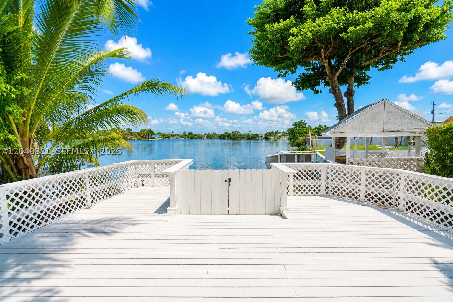 Waterfront in Highland Lakes, Aventura, oversized inside an exclusive 24-hour guard-gated community. This villa features 4 bedrooms and 3 bathrooms, offering bright, open living spaces filled with natural light. The kitchen showcases granite countertops, stainless steel appliances, and a spacious center island perfect for entertaining. The bathrooms feature premium fixtures and frameless glass showers, while large-format porcelain flooring and LED recessed lighting add a sleek contemporary touch throughout. Step outside to an expansive waterfront deck overlooking the lake, complete with a private dock and boat ramp. Ideal for enjoying South Florida's outdoor lifestyle. Located just steps from Aventura Waterways K-8 School and minutes from the beach, Aventura Mall, Gulfstream Park, world-class dining, and I-95. A rare opportunity to own a move-in-ready waterfront home in one of Aventura's most sought-after gated communities. Owner is looking for a long-term tenant.
