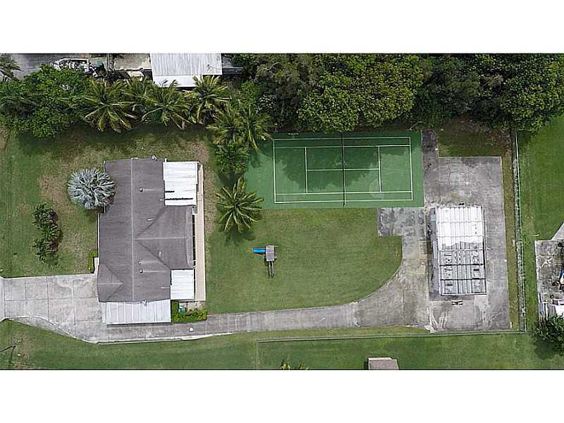 Welcome to Fla Fruit Lands, an equestrian community with one acre of land, this property features, 3 bedrooms and 2 bathrooms, Playroom that may be converted to a 4th bedroom, no HOA, CITY WATER!!!, wood and tile floors, aluminum shutters, 1,000 sq. ft. d etached garage/workshop and 1bed 1 bath efficiency, playground, tennis and basketball court, make this your own resort.  Roof was replaced in 2002 and A/C in 2006.