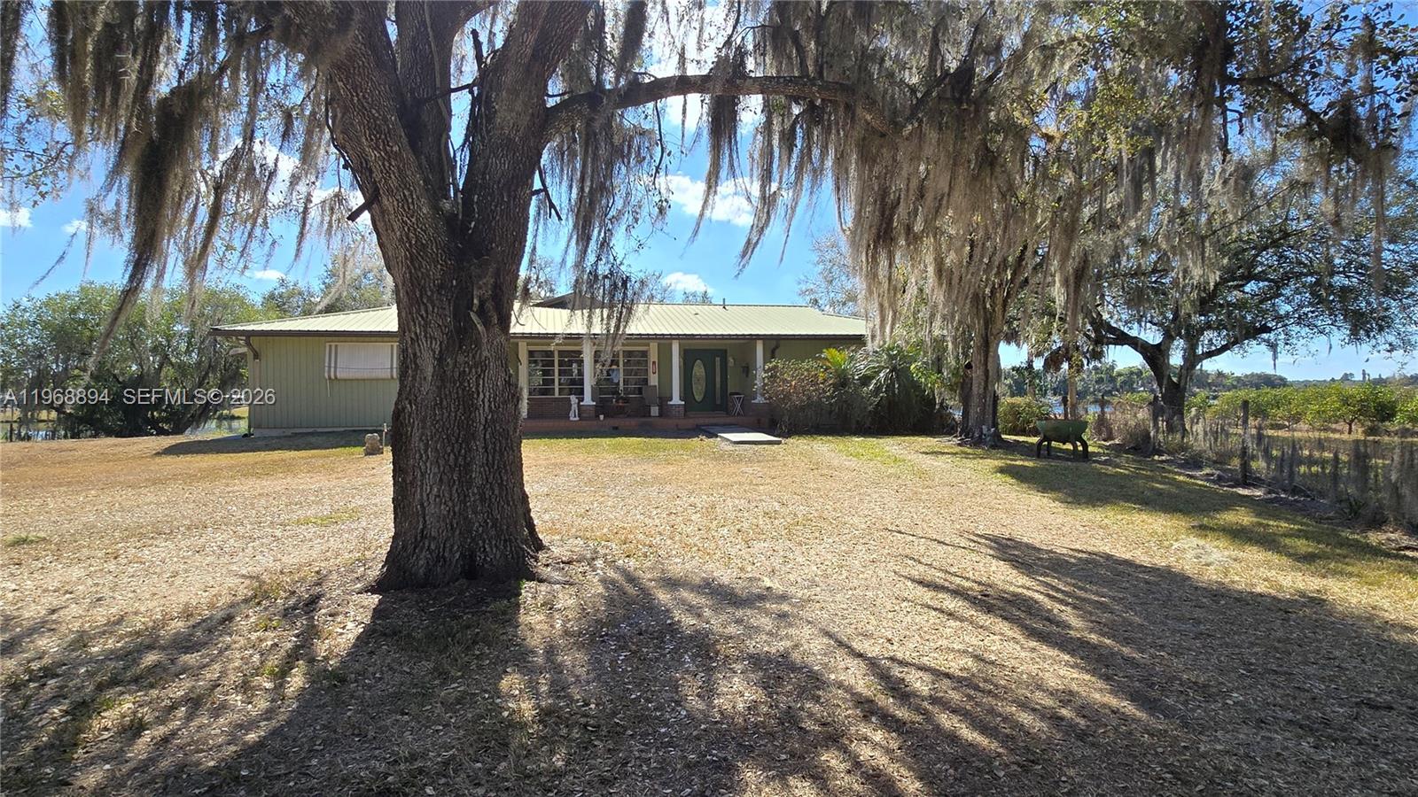 Navigate Florida's iconic waterways from Port St. Lucie on the Atlantic all the way to Fort Myers on the Gulf - right from your backyard. This impressive 4 bedroom 3 bath home offers 2985 SF of beautifully finished living space, plus an additional 2500 SF basement, currently used as a workshop with a view, but can easily be transformed into more living space, a guest suite, or a fully separate apartment. Set on 2.5 oak laden acres, the property also includes a 125' concrete slab, the perfect foundation for a Butler building, workshop, storage facility or future expansion. With 130 feet of pristine frontage on the Calooshatchee River, a boathouse and deck, you'll enjoy effortless access to the water and endless opportunities for adventure. And the views - sunrise to sunset, every single day - are nothing short of spectacular. Step outside to outdoor livng spaces galore, ideal for entertaining, relaxing, and soaking in the beauty of the riverfront lifestyle. A rare blend of space, freedom and waterfront living.