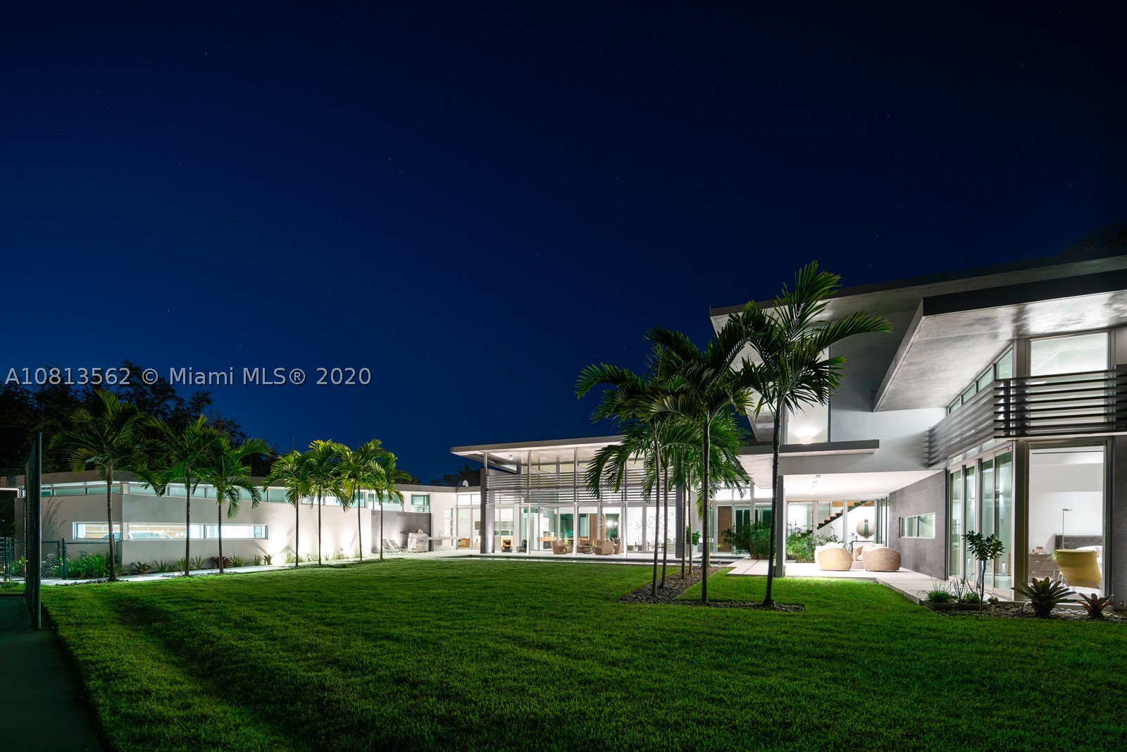 Modern and Mid-Century  marvel of custom architecture and engineering, flawlessly executed. Designed by KZ Architecture,  discover new wonders at every view: soaring ceilings, natural elements, glass framed views combine for a design that is anything but “white box.” Imagine yourself living in a work of art, enjoying your first floor master wing with, spa bath, private gated corner acre, reflection and heated pool and N/S tennis court. Home features poured in place cement roof with ceilings floating on beams, sculptural floating wood and glass staircase, LED lighting, and custom cabinetry. Great family/guest floor plan with upstairs loft and 3 suites. Staff room. Gym and office conv to bedroomms. More attached.