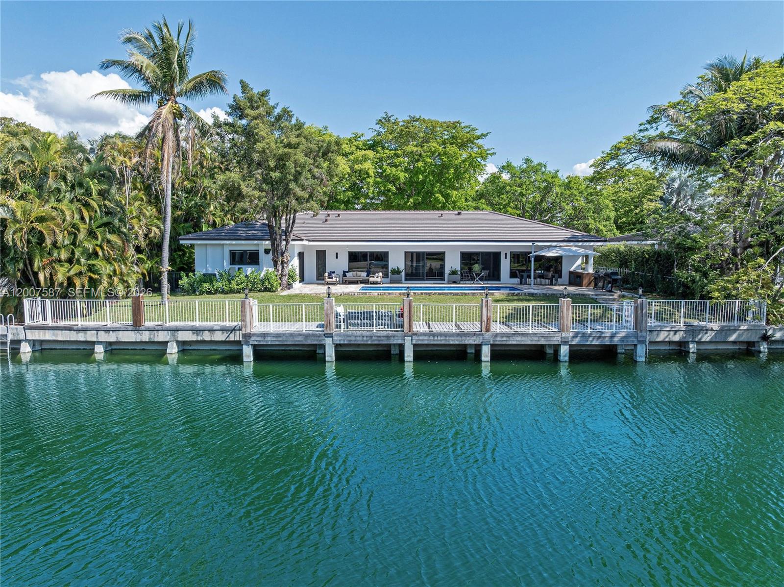 Located in Gables by the Sea, this fully renovated waterfront home sits on a 12,300 sq ft lot. Finished in January 2026 with Coral Gables permits, updates include roof, plumbing, electrical, impact windows and doors, two A/C units, two water heaters, and a new driveway. The 3,048 sq ft (living area) layout includes 4 bedrooms with en-suite baths and walk-in closets, plus a den. Features include open living, electric shades, and a Lutron system. Brand new kitchen with Italian cabinetry and Thermador appliances. Remodeled pool, quartzite counter area with cabinetry and sink, and cabana bath.