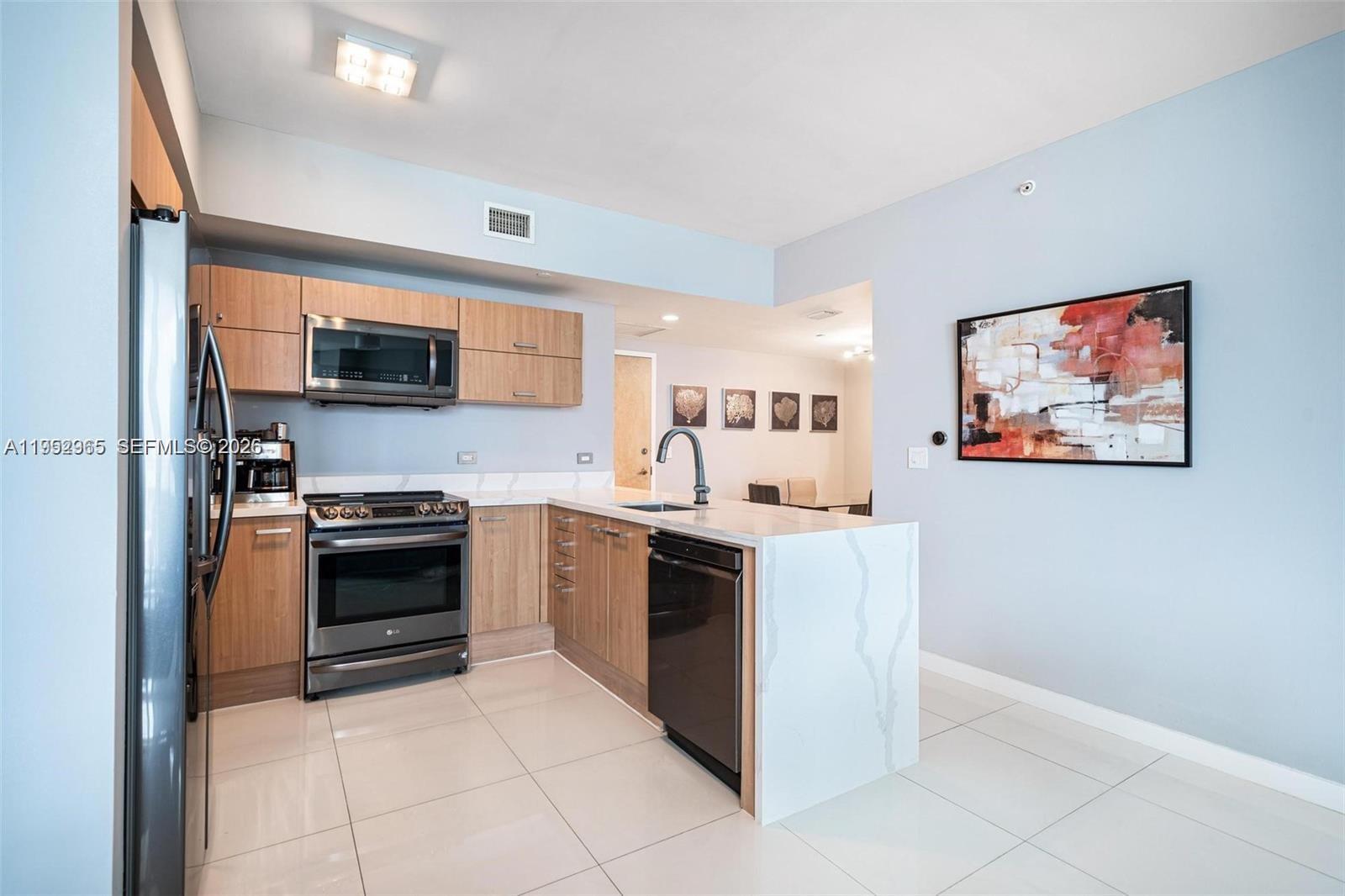 Experience luxury living in this 2 bed / 2 bath + den residence with sweeping views of the Miami skyline and river. The split floorplan features a newer kitchen with quartz countertops, updated appliances, and an in-unit washer and dryer. Bathrooms offer elegant upgrades including glass-enclosed showers, floating vanities, and a tankless water heater. Additional features include electronic shades, blackout bedroom curtains, custom closets, and full-service high-rise living with 24/7 security, pool, gym, sauna, business center, valet, and one assigned parking space. Agents: see broker remarks for showings and times.