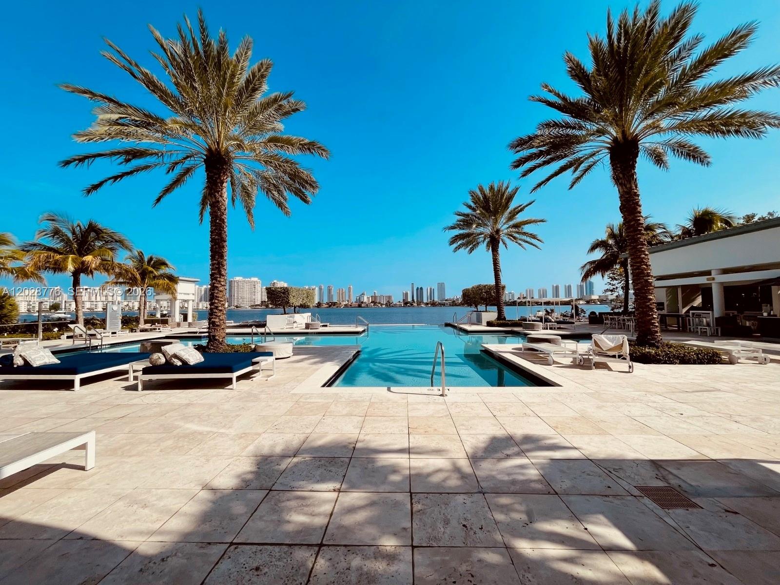 Experience elevated waterfront living at Marina Palms Residences with this exceptional 2-bedroom + den, 3-bathroom residence. Unit 208 offers an expansive floor plan, sophisticated contemporary finishes, and breathtaking water views from virtually every room. Designed for both comfort and style, this residence features floor-to-ceiling windows that fill the home with natural light while showcasing serene marina and waterfront vistas. The versatile den provides the perfect space for a home office, media room, or guest accommodations. Three beautifully appointed bathrooms add convenience and luxury for residents and guests alike. Marina Palms Residences is a premier waterfront community offering world-class amenities, including a resort-style pool, state-of-the-art fitness center, spa, children's play area, business center, 24-hour concierge, valet service, and a private marina with direct ocean access. Ideally located in North Miami Beach, residents enjoy easy access to premier shopping, dining, entertainment, and the area's beautiful beaches. Don't miss this rare opportunity to own a luxury waterfront residence in one of South Florida's most sought-after communities. Schedule your private showing today and discover the Marina Palms lifestyle.