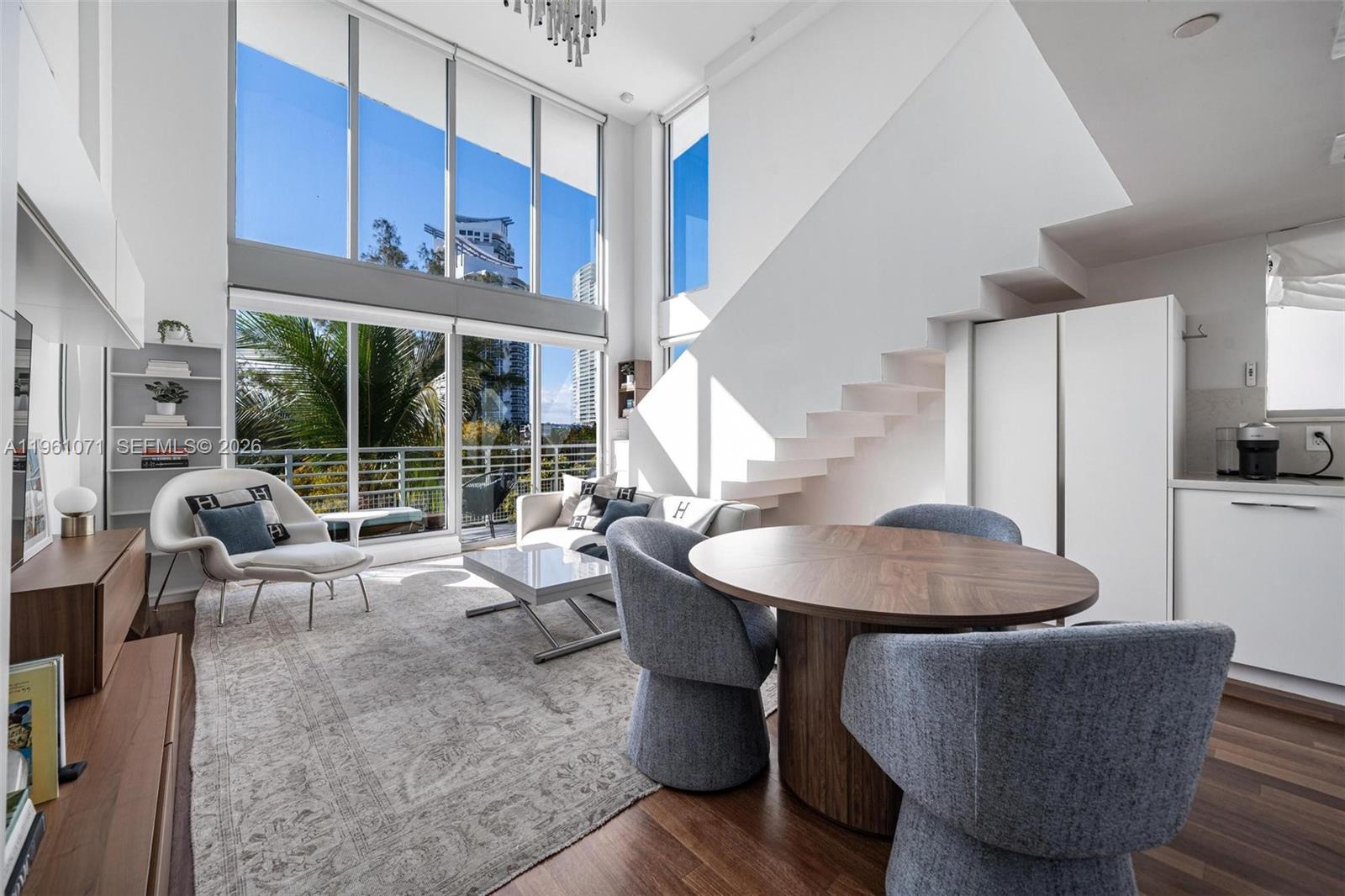 Unique architectural two-story loft penthouse with a private rooftop terrace in the heart of South of Fifth (SoFi).
Defined by soaring 16-foot ceilings and dramatic floor-to-ceiling impact windows, the double-height living space is filled with natural light and showcases western exposures with stunning sunset views toward Biscayne Bay. This two-bedroom, two-bathroom residence offers 1,488 sq ft of interior living space.
A standout feature is the private 332 sq ft rooftop terrace, accessed separately from the main living areas, offering sweeping views of Fisher Island, the Port of Miami, and Miami Beach sunsets—ideal for entertaining or relaxing above it all.
The updated kitchen features Bosch appliances, modern cabinetry, and upgraded finishes, complemented by renovated bathrooms and dual walk-in closets with custom built-ins.
Built in 2004, the residence includes two assigned parking spaces, bike and motorcycle storage, and pet-friendly policies. The boutique building offers a low HOA and has completed major improvements, including a renovated pool, modernized elevators, and upgraded security.
Located moments from South Pointe Park, the marina, beach access, Whole Foods, Pura Vida, cafés, and top dining, this penthouse offers a rare opportunity in one of Miami Beach’s most desirable neighborhoods.