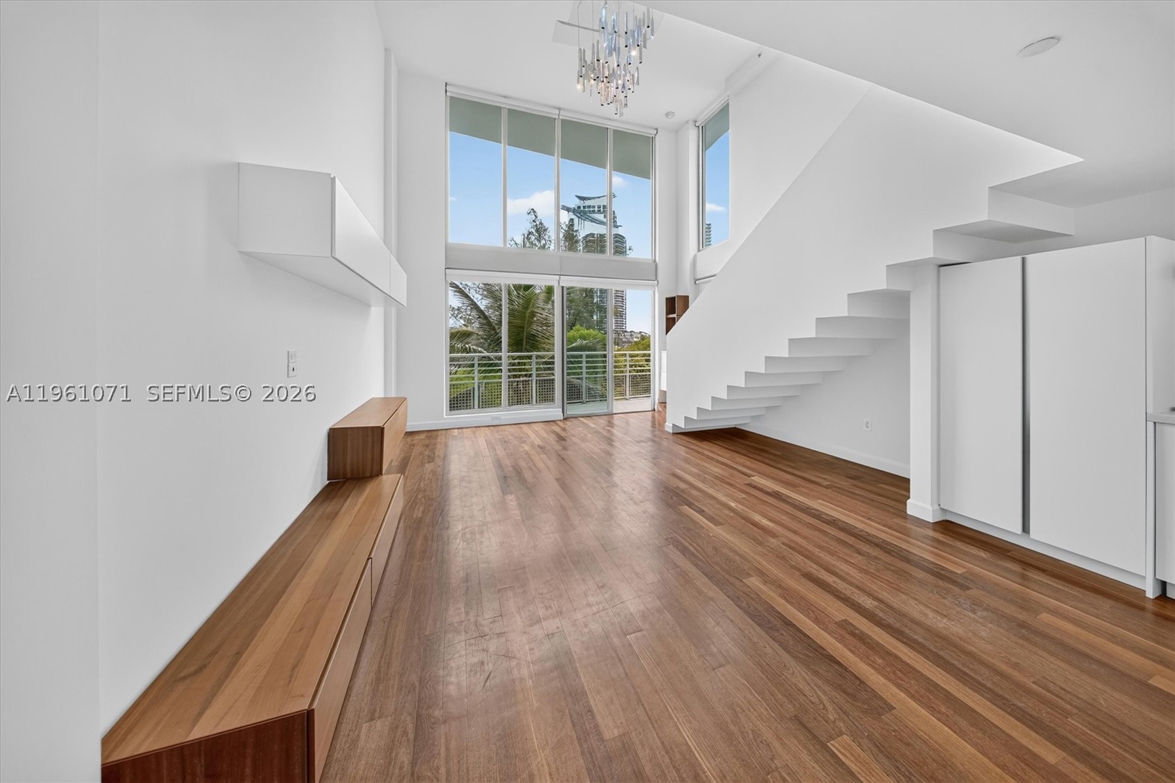 Unique architectural two-story loft penthouse with a private rooftop terrace in the heart of South of Fifth (SoFi).
Defined by soaring 16-foot ceilings and dramatic floor-to-ceiling impact windows, the double-height living space is filled with natural light and showcases western exposures with stunning sunset views toward Biscayne Bay. This two-bedroom, two-bathroom residence offers 1,488 sq ft of interior living space.
A standout feature is the private 332 sq ft rooftop terrace, accessed separately from the main living areas, offering sweeping views of Fisher Island, the Port of Miami, and Miami Beach sunsets—ideal for entertaining or relaxing above it all.
The updated kitchen features Bosch appliances, modern cabinetry, and upgraded finishes, complemented by renovated bathrooms and dual walk-in closets with custom built-ins.
Built in 2004, the residence includes two assigned parking spaces, bike and motorcycle storage, and pet-friendly policies. The boutique building offers a low HOA and has completed major improvements, including a renovated pool, modernized elevators, and upgraded security.
Located moments from South Pointe Park, the marina, beach access, Whole Foods, Pura Vida, cafés, and top dining, this penthouse offers a rare opportunity in one of Miami Beach’s most desirable neighborhoods.
