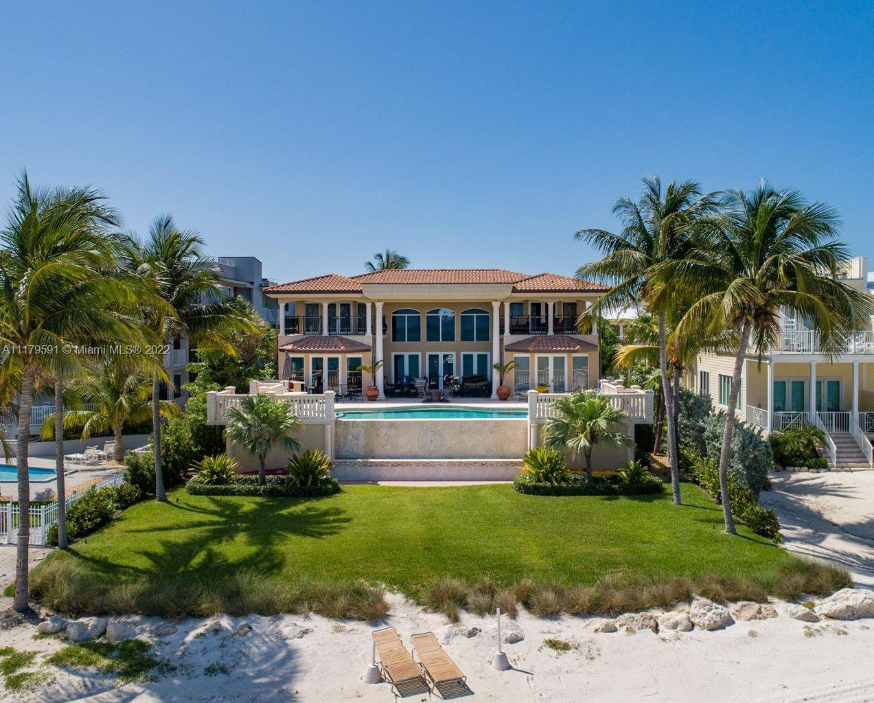 Here is the ultimate beachfront estate for the island life you have always dreamed of. Gated & lushly landscaped for the privacy you deserve. Mesmerizing, wide open ocean views from almost every room in this home. The grand living room flows effortlessly from the kitchen, dining room & master bedroom, onto the massive patio with infinity pool over YOUR sandy beach. Enchanting, ocean views continue into your Master Suite with dressing room & custom bath & triple vanities. Travel by elevator from 4 car garage to main living area & upper master su & guest bedroom both w/private ocean front balconies. Completing the 2nd level, a 4th guest bedroom & guest bathroom adjacent by catwalk overlooking open concept living, dining and kitchen. Complete with In-Law Apartment for friends & family.