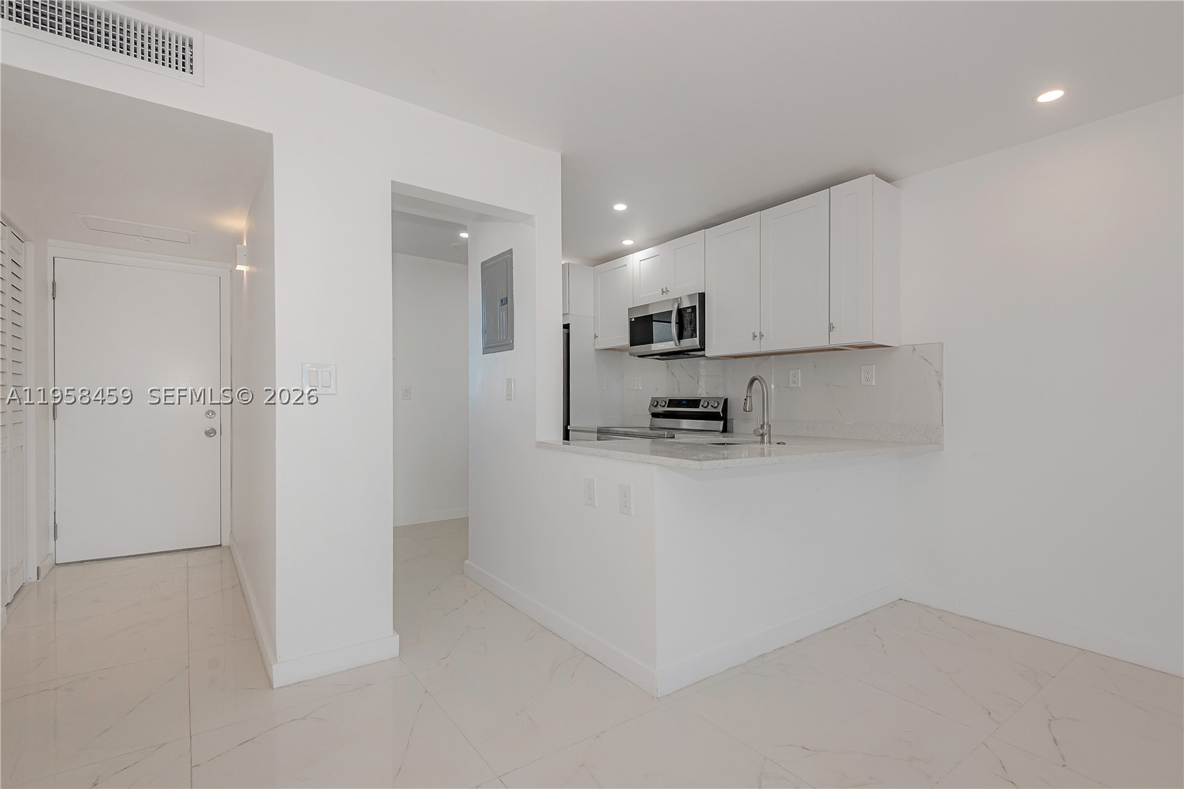 Beautifully renovated and fully remodeled. 1 bedroom, 1 bath residence featuring an open white kitchen with quartz countertops and stainless steel appliances, including dishwasher. White porcelain tile flooring throughout. Spacious layout with two walk-in closets. New paint and hi hat lighting, new A/C and water heater. Enjoy serene lake views from this beautifully updated home. Residents can enjoy variety of amenities including a clubhouse, gym, billiards, bingo, bowling, card room, table tennis and 5 pools. The community also has a 2 mile walking path around the complex, perfect for leisurely strolls by the lake and bay. A courtesy bus provides convenient transportation to the mall, nearby beach, shopping centers, and restaurants. This gated community offers a secure and active lifestyle. 55+ community