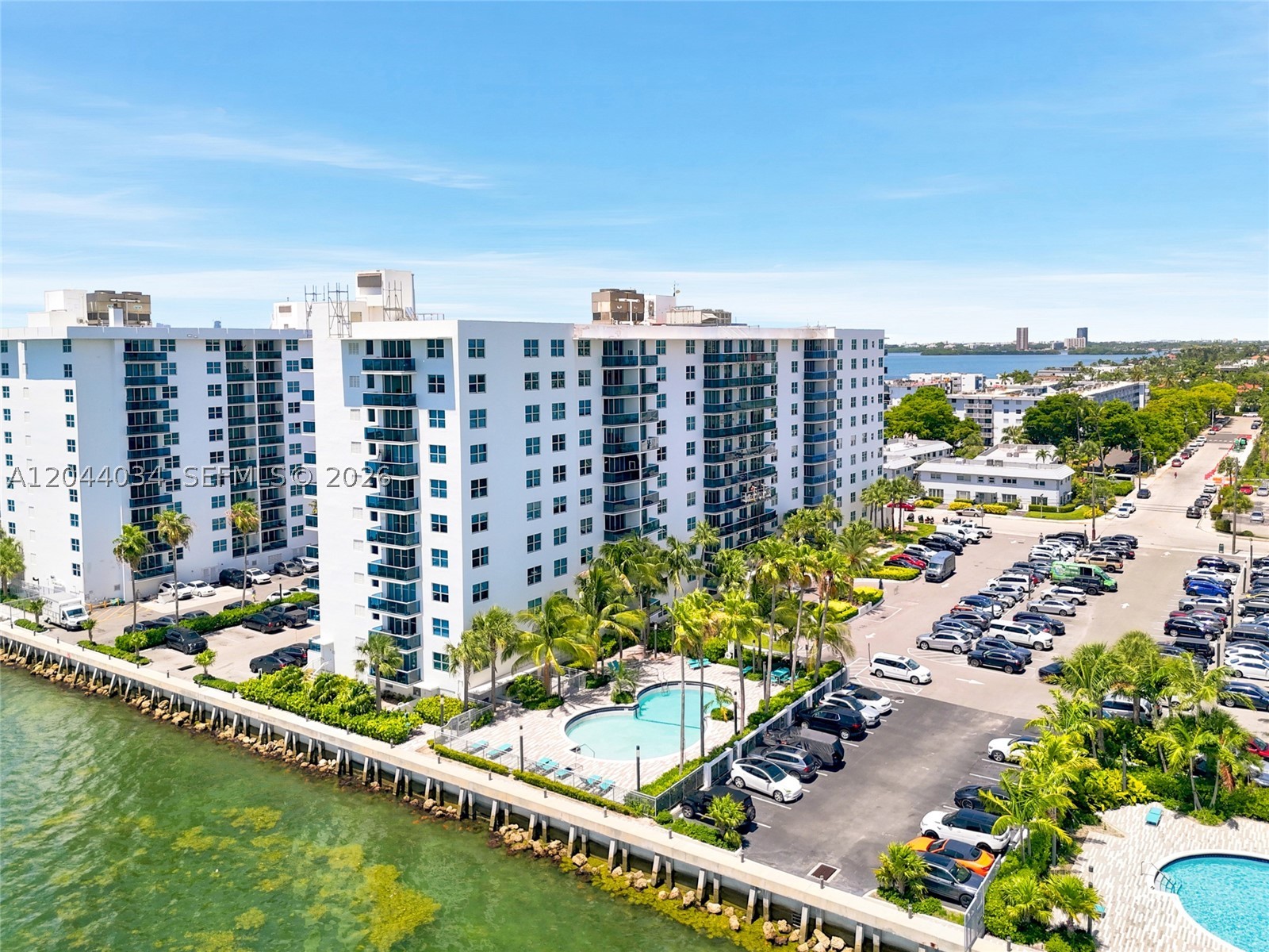 Turnkey renovated 1BD/1BA — 825 SF — at Treasures on the Bay II on Treasure Island, North Bay Village. This 2nd-floor residence opens to a private balcony with sweeping bay and city views. Includes assigned parking plus valet. Resort-style amenities: three bayfront pools, 24-hour gym, BBQ areas, bayfront boardwalk, and a lobby convenience store. Steps from Treasures Elementary with a new Publix on the way — Miami Beach, Wynwood, Midtown, and MIA all within ~20 minutes. Seller is paying the upcoming building assessment in full for a clean handoff. Currently leased at $2,350/mo — an ideal turnkey investment or future primary residence.