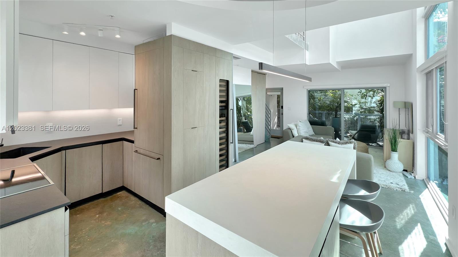 This exclusive South Beach private residence offers luxury in a prime location without the hassle of highrise living, with very low maintenance fees. Modern Tri level townhouse loft style 2 bedrooms, 2.5 bath with 1428 sq feet under A/C residence. Space boasts soaring 28' ceilings, completed with luxury finishes and appliances in South Beach. The second level offers 2 comfortable bedrooms with in-suite bathrooms, plus a washer and dryer. Dramatic floor-to-ceiling, high-impact resistant windows and stained concrete flooring throughout. Includes 1 covered assigned parking space in a gated garage. Generating $6600 per month. Very low maintenance fee. Walking distance to the beach, Flamingo Park, Lincoln Road, shops, and restaurants. Publix, Total Wine, and Whole Foods are just around the corner. Quiet and secure boutique building with only 7 TH units.
