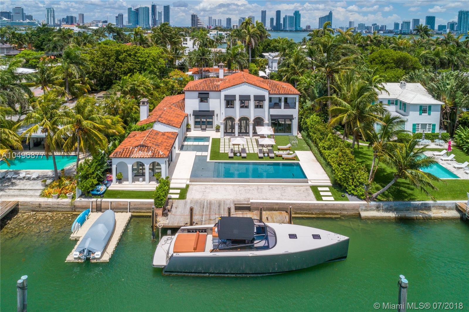 Impressive Italian Villa designed by architect Peter Hawrylewicz. Completely renovated in 2017. 17,500 SF lot w/100' of open water views over new infinity pool. IPE dock, manicured landscaping, large outdoor pavilion w/fireplace, separate guest house w/cabana bath & 2-car garage compliment this 6,827 SF Villa. Home features: UV treated impact doors/windows, wood floors throughout, groin vault & pecky cypress ceilings, new Italian kitchen w/island, huge master suite w/Jacuzzi, private terrace & large walk-in closet.