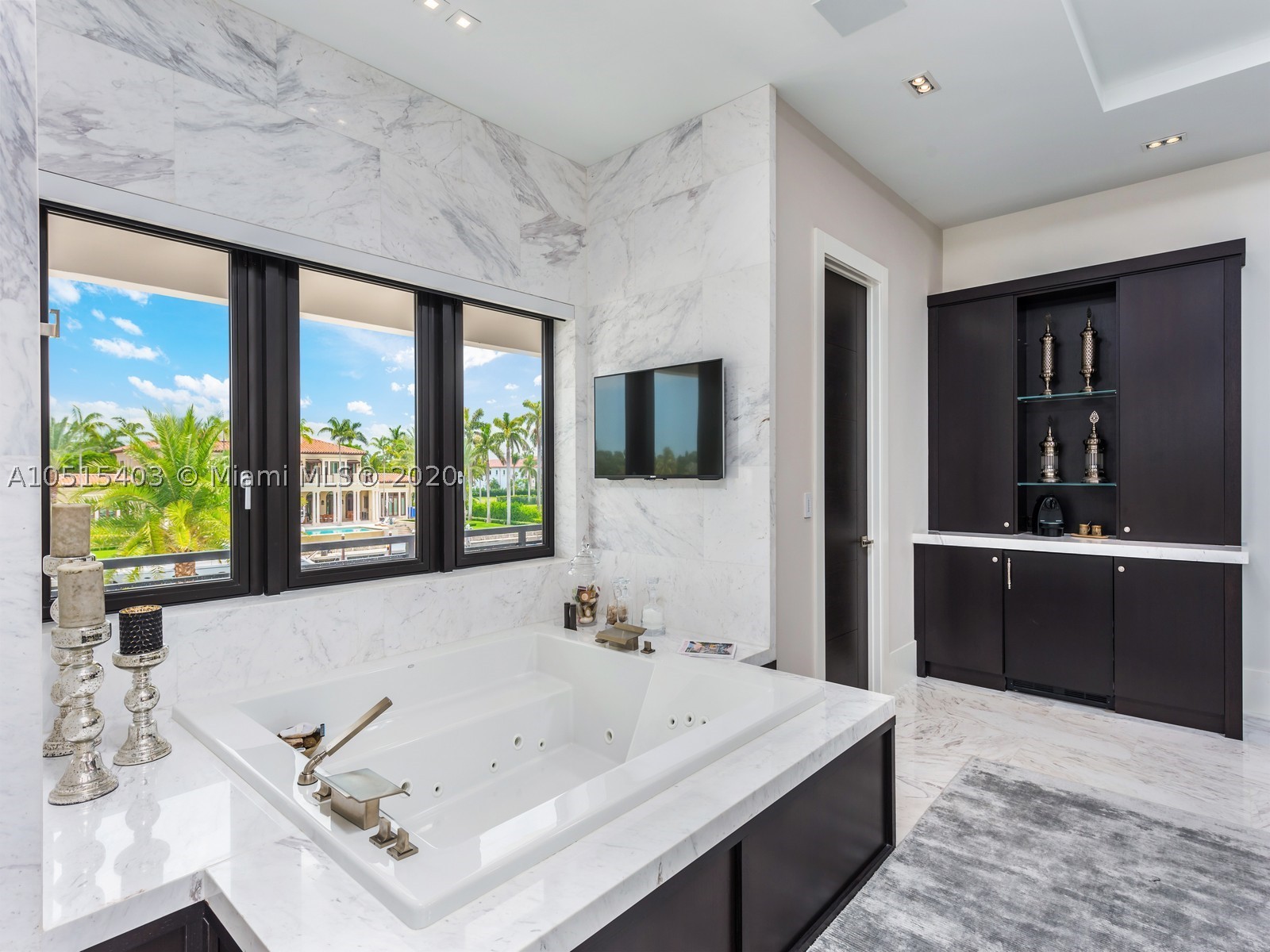 The most stunning home in the exclusive guard-gated community of Gables Estates. Premiere 255ft of water frontage w/160ft dock situated on the widest part of the canal just a few seconds from the bay w/direct ocean access. Extraordinary 2017 home w/fabulous views of garden & waterway will exceed your expectations of a unique lifestyle allowing natural light to radiate throughout every rm. Feat: impressive master ste w/sitting area overlooking the water & enormous marble bathrm spa style w/outdr summer shower, 14 seat estate of the art theater rm w/optic ceiling lights, game rm w/wet bar/wine cellar. Outdr entertainment area w/summer kit & Teppanaki table, covered terr, rooftop deck, infinity edge heated pool w/fire bowls & fountains. VISIT OUR PROPERTY VIDEO: https://youtu.be/yfcxHdDv_4g