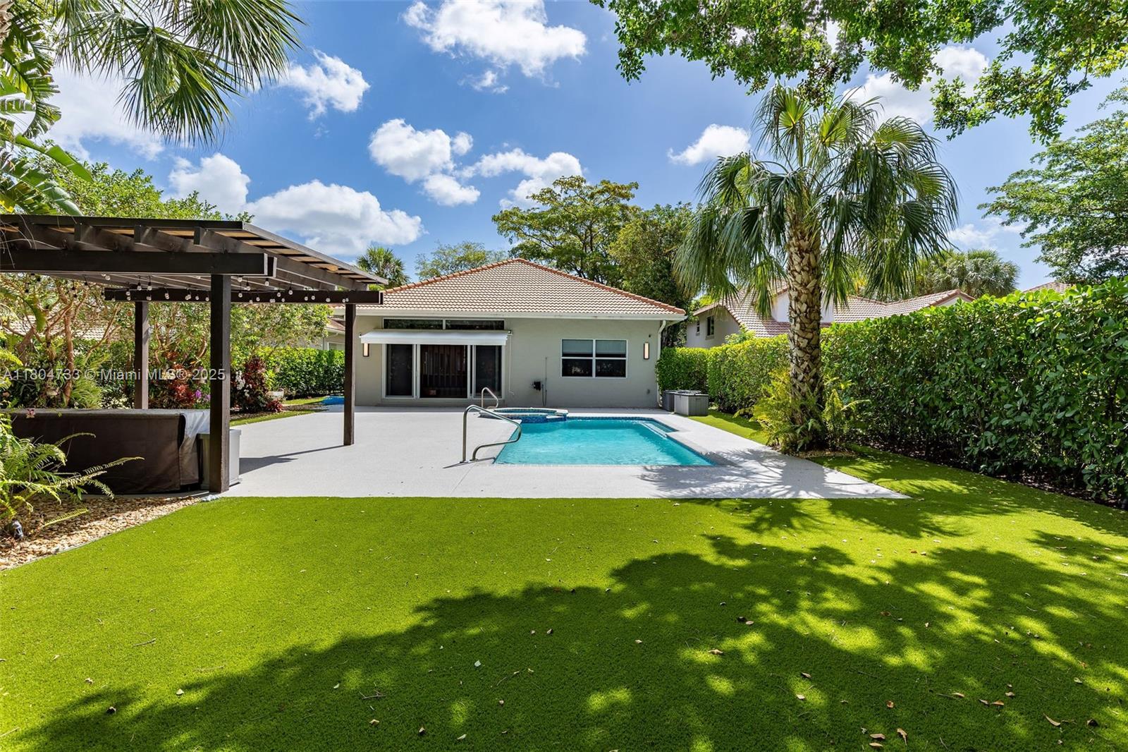 Experience luxury living in this modern 4-bedroom, 4-bath home in Palm Aire.  A Sunlit open-concept living area flows into a gourmet kitchen equipped with quartz countertops and a Wolf professional range, perfect for the avid home chef. Entertain with ease in the separate bar and family room, offering ample space for gatherings, and step outside to your private garden oasis featuring a renovated pool area and pergola—ideal for relaxing or hosting outdoor get-togethers year-round. This home is equipped with impact windows and doors for peace of mind, two AC units with smart thermostats, and electric blinds to keep you comfortable in all seasons. Set on an expansive 12,144 sq ft lot, this residence combines luxury and lifestyle in the heart of the desirable Palm Aire community.