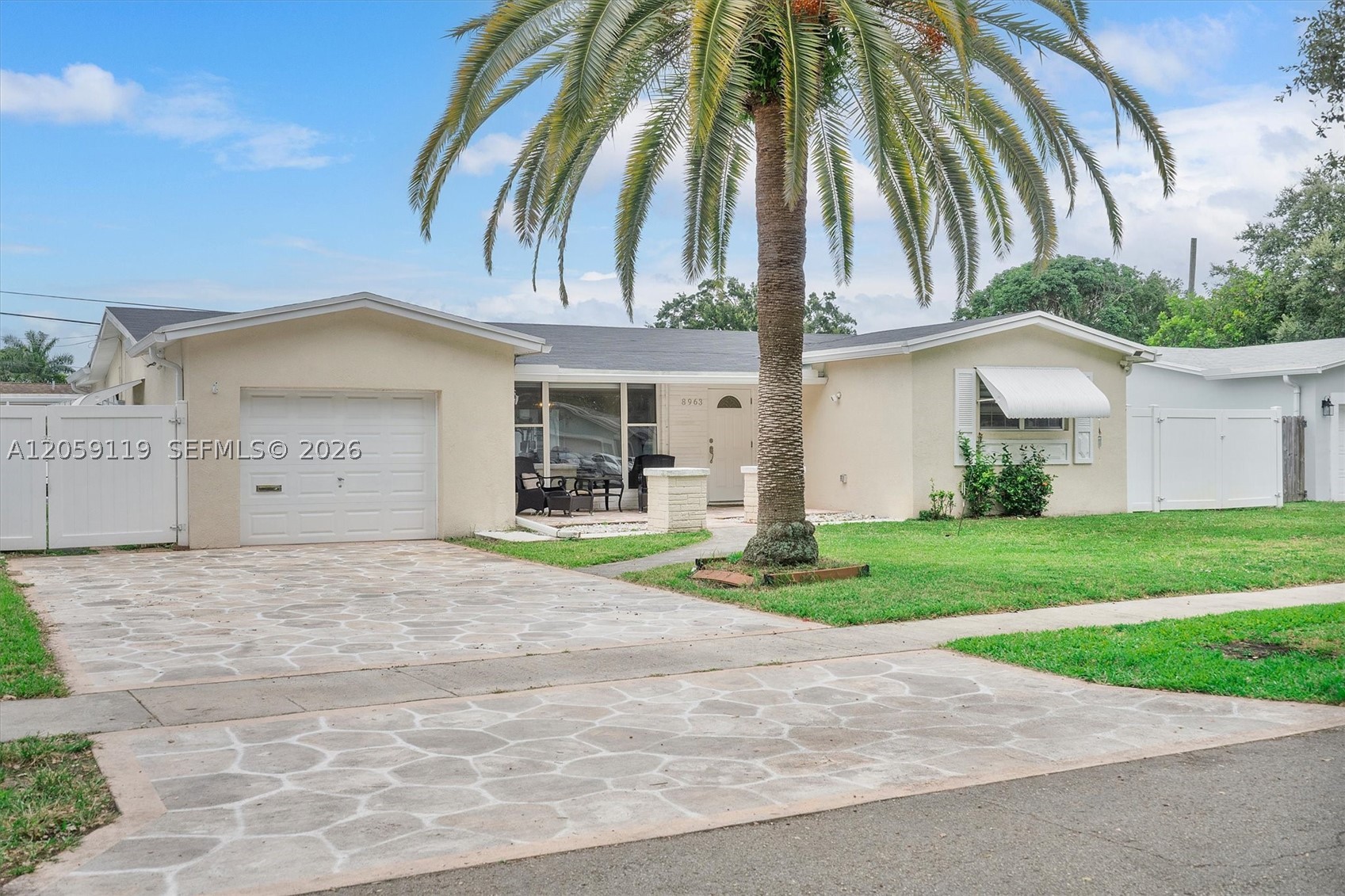 Filled with natural light and thoughtfully updated throughout, this 3-bed, 2-bath home in highly sought-after Cooper Colony Estates offers NO HOA and access to Cooper City’s highly regarded schools, including Cooper City Elementary, Pioneer Middle, and Cooper City High. Oversized windows and expansive sliding glass doors create a bright, inviting atmosphere, while dual-layer shades provide the perfect balance of privacy and natural light. The functional split floor plan features wood-look porcelain flooring throughout, spacious living and dining areas, an expansive family room, and a breakfast area. The renovated kitchen offers custom wood cabinetry, Carrara quartz countertops, stainless steel appliances, and a pass-through window overlooking the oversized covered and screened patio, creating a seamless indoor-outdoor living experience. The primary suite features generous closet space and an updated bath, while two additional bedrooms share an updated bathroom with a double-sink vanity. Additional features include abundant storage, a fully insulated one-car garage with laundry and side-yard access, and a spacious backyard enclosed by a newer PVC privacy fence. Most major components have been updated in recent years, including the 2023 roof, kitchen, flooring, AC, water heater, fencing, and more. With an ideal blend of modern updates, generous living spaces, and an unbeatable Cooper City location, this home is ready for its next family to make it their own for years to come.