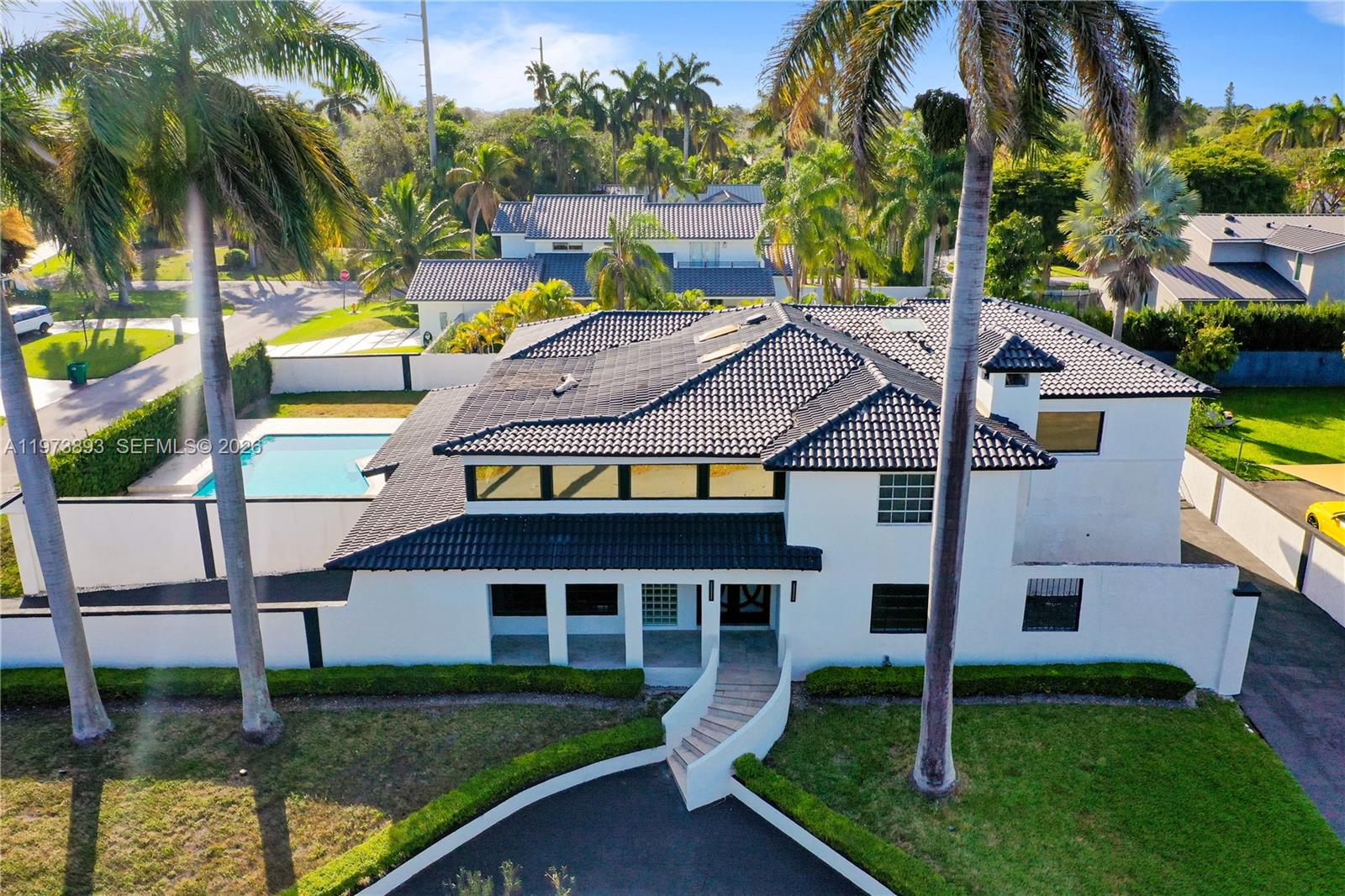 Beautifully upgraded two-story home in the desirable Village of Palmetto Bay. As per last appraisal Gross living area 4,727 sqft. This move-in ready residence features a modern open floor plan, double-height entry, floating staircase, and abundant natural light. The home offers numerous upgrades throughout, impact windows and doors, and stylish modern finishes.

Enjoy a private backyard with a sparkling pool and spa, expansive patio, and covered terrace ideal for outdoor entertaining. Spacious lot with excellent curb appeal, located on a quiet street near top-rated schools, parks, shopping, and dining.

**Upgraded home with pool in one of Palmetto Bay’s most sought-after neighborhoods. Schedule your showing today.**
The property sits on a spacious lot in a quiet, tree-lined neighborhood known for its top-rated schools and family-friendly environment.