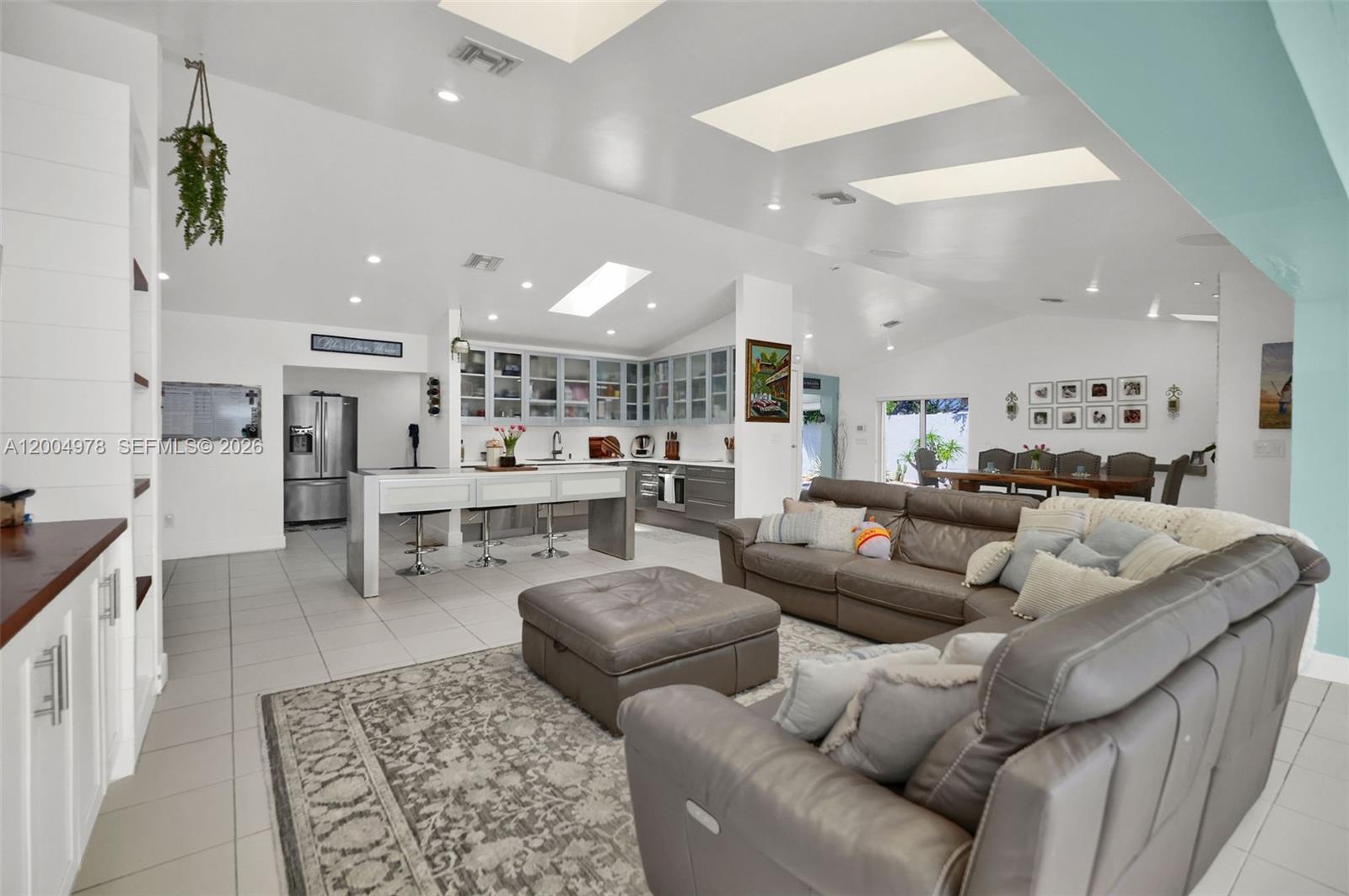 Step into this beautifully designed home featuring a grand foyer entrance that overlooks a serene courtyard with the potential to create your own koi pond retreat. High and vaulted ceilings, along with numerous skylights, fill the home with incredible natural light. The split-bedroom floor plan offers privacy, highlighted by a luxurious primary suite with a sleek modern bathroom, standalone soaking tub, and an expansive custom-built dream closet.

At the heart of the home is a modern kitchen with European-style cabinetry, with space that can easily be converted into a butler’s pantry/utility area—perfect for entertaining. The living room showcases custom built-in shelving and entertainment storage, enhanced by built-in speakers throughout.

Enjoy versatile living spaces including a den ideal for a home office or gym, plus a playroom that can easily convert into an additional bedroom. The Florida sunroom overlooks the expansive backyard with ample room for a pool, offering the perfect indoor-outdoor lifestyle.

Additional features include impact windows and doors, a 2-car garage, and a spacious carport. This home blends functionality, elegance, and comfort in every detail.