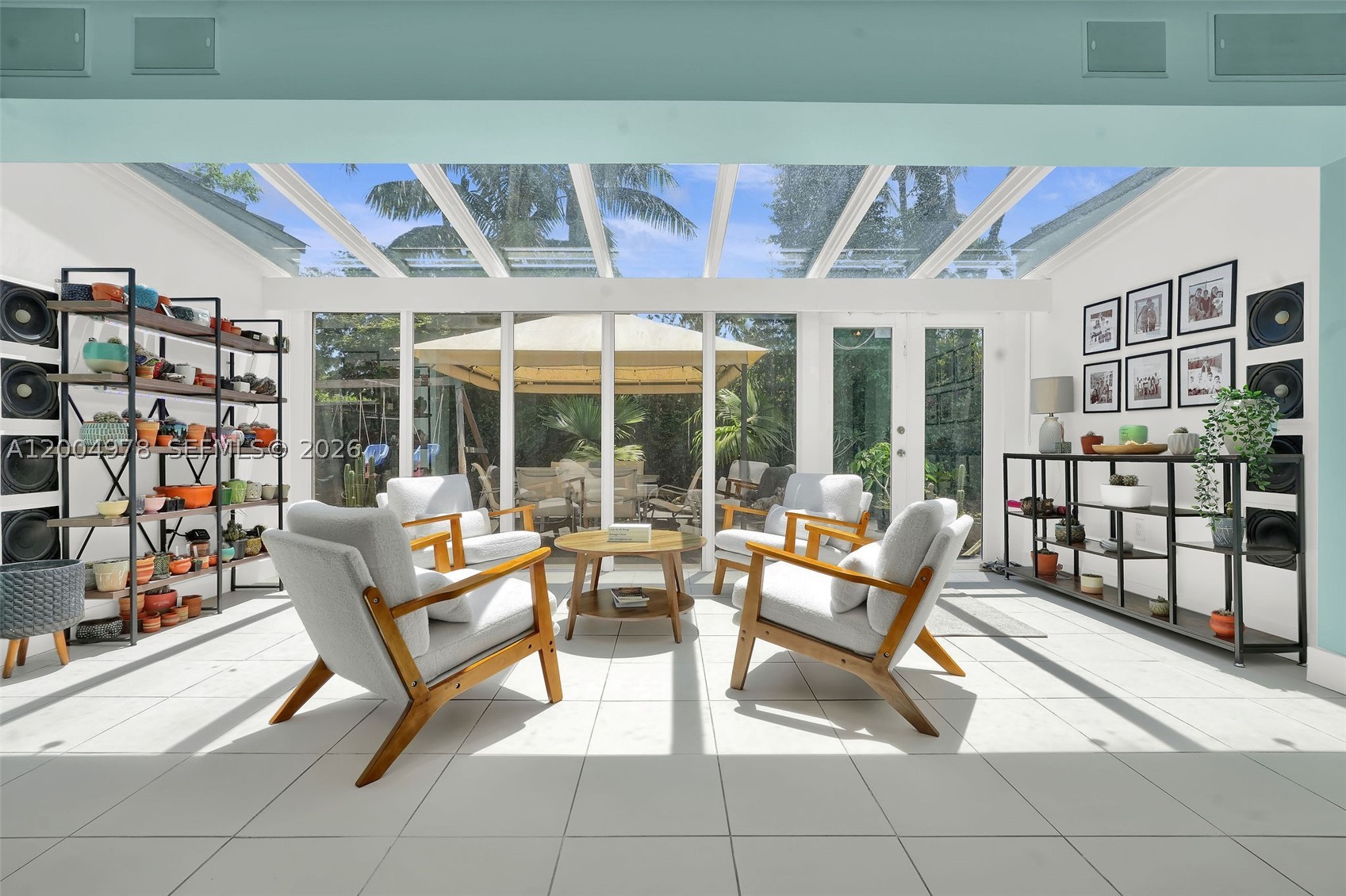 Step into this beautifully designed home featuring a grand foyer entrance that overlooks a serene courtyard with the potential to create your own koi pond retreat. High and vaulted ceilings, along with numerous skylights, fill the home with incredible natural light. The split-bedroom floor plan offers privacy, highlighted by a luxurious primary suite with a sleek modern bathroom, standalone soaking tub, and an expansive custom-built dream closet.

At the heart of the home is a modern kitchen with European-style cabinetry, with space that can easily be converted into a butler’s pantry/utility area—perfect for entertaining. The living room showcases custom built-in shelving and entertainment storage, enhanced by built-in speakers throughout.

Enjoy versatile living spaces including a den ideal for a home office or gym, plus a playroom that can easily convert into an additional bedroom. The Florida sunroom overlooks the expansive backyard with ample room for a pool, offering the perfect indoor-outdoor lifestyle.

Additional features include impact windows and doors, a 2-car garage, and a spacious carport. This home blends functionality, elegance, and comfort in every detail.