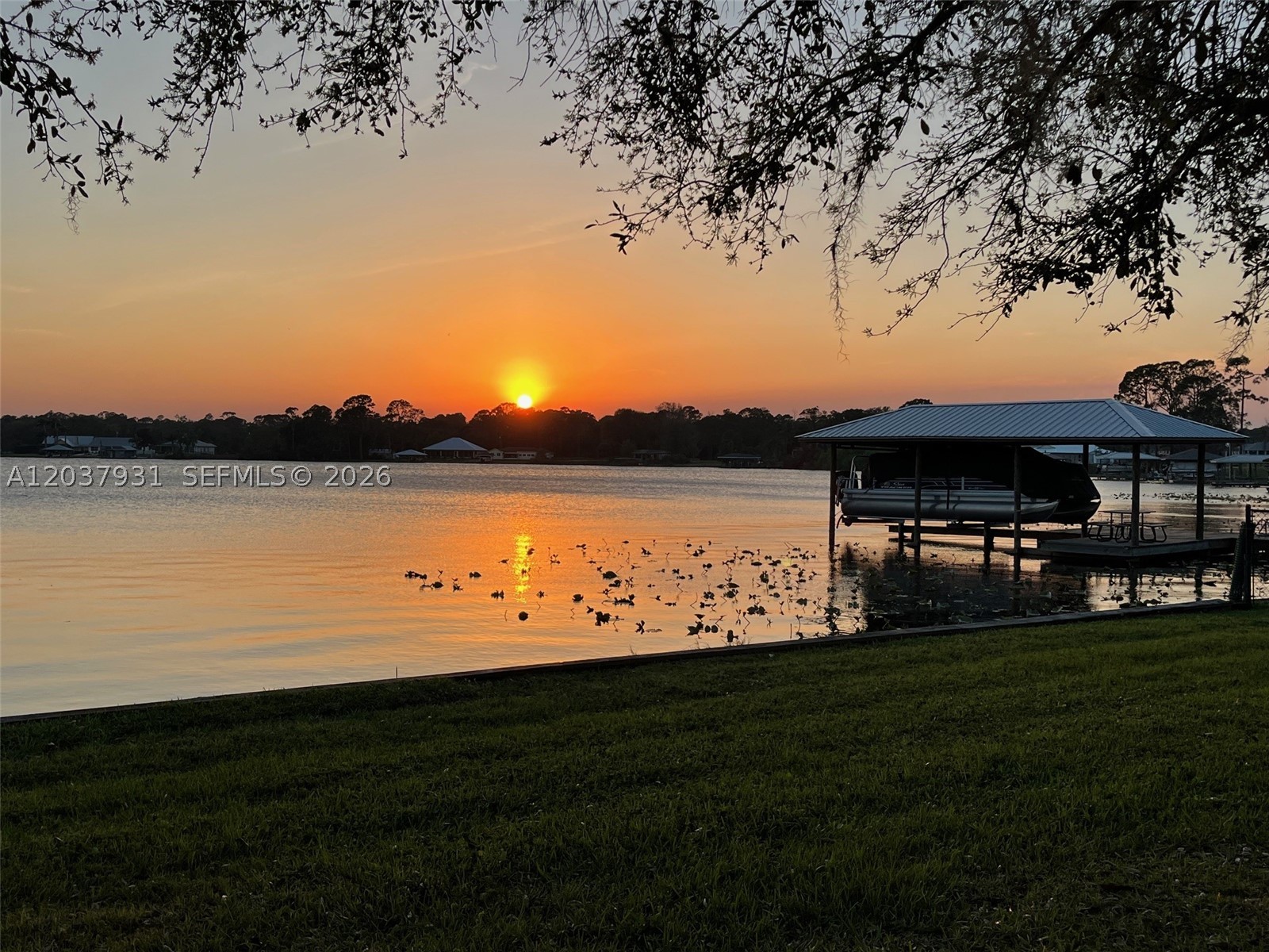 Spectacular waterfront paradise fully furnished on lake Carrie; 3 bedrooms/3 baths, in a fenced in property in Lake Placid, the Caladium Capital of the World and The Town of Murals. This home can accommodate up to 16 guests. Romantic and tranquil setting! Your entire family can enjoy this stylish gorgeous home on Lake Carrie, known for its Spring fed water & sandy bottom; enjoy fishing, skiing, tubing, canoeing, kayaking, including paddle boarding. Lake Carrie connects to Lake Henry and huge Lake June. The boat house is equipped with swings, tables & chairs for a quiet dining. Or just relax and enjoy the amazing sunsets from the Jacuzzi in the screened porch. Price may vary during season. Must see.