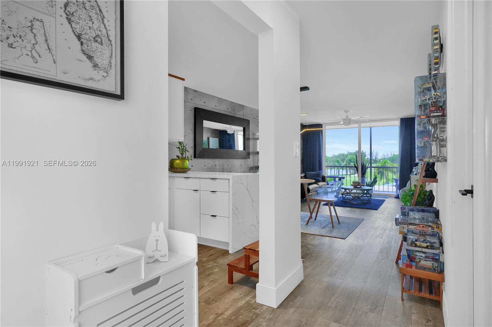 LUXURY VIEWS, DESIGNER UPGRADES, AND UNMATCHED VALUE- ALL IN ONE. Just amazing. This fully remodeled corner residence offers beauty throughout and million-dollar golf course, lake, and tennis views. Move right in to this tastefully updated 1-bedroom, 1.5-bath residence featuring beautiful flooring throughout. The open-concept kitchen showcases stainless-steel appliances, while impact windows and doors provide both style and peace of mind. The unit also includes a washer and dryer for added convenience. This property includes a spacious exterior storage unit and two assigned parking spaces. The recreation lease has been paid in full—an exceptional value. Ideally located just steps from the pool, clubhouse, restaurant, and golf pro shop. Enjoy free golf (cart fees apply), with an association that includes water, basic cable TV, and internet. Resort-style amenities include a restaurant, billiard room, BBQ/picnic area, clubhouse, courtesy bus, fitness center, heated pool, library, putting green, sauna, shuffleboard, tennis and pickleball courts, vehicle wash area, and electric car charging station. Conveniently located near shopping, dining, and major highways. Please note: Rentals are not permitted during the first 9 months of ownership. An effortless blend of elegance and tranquility !!!