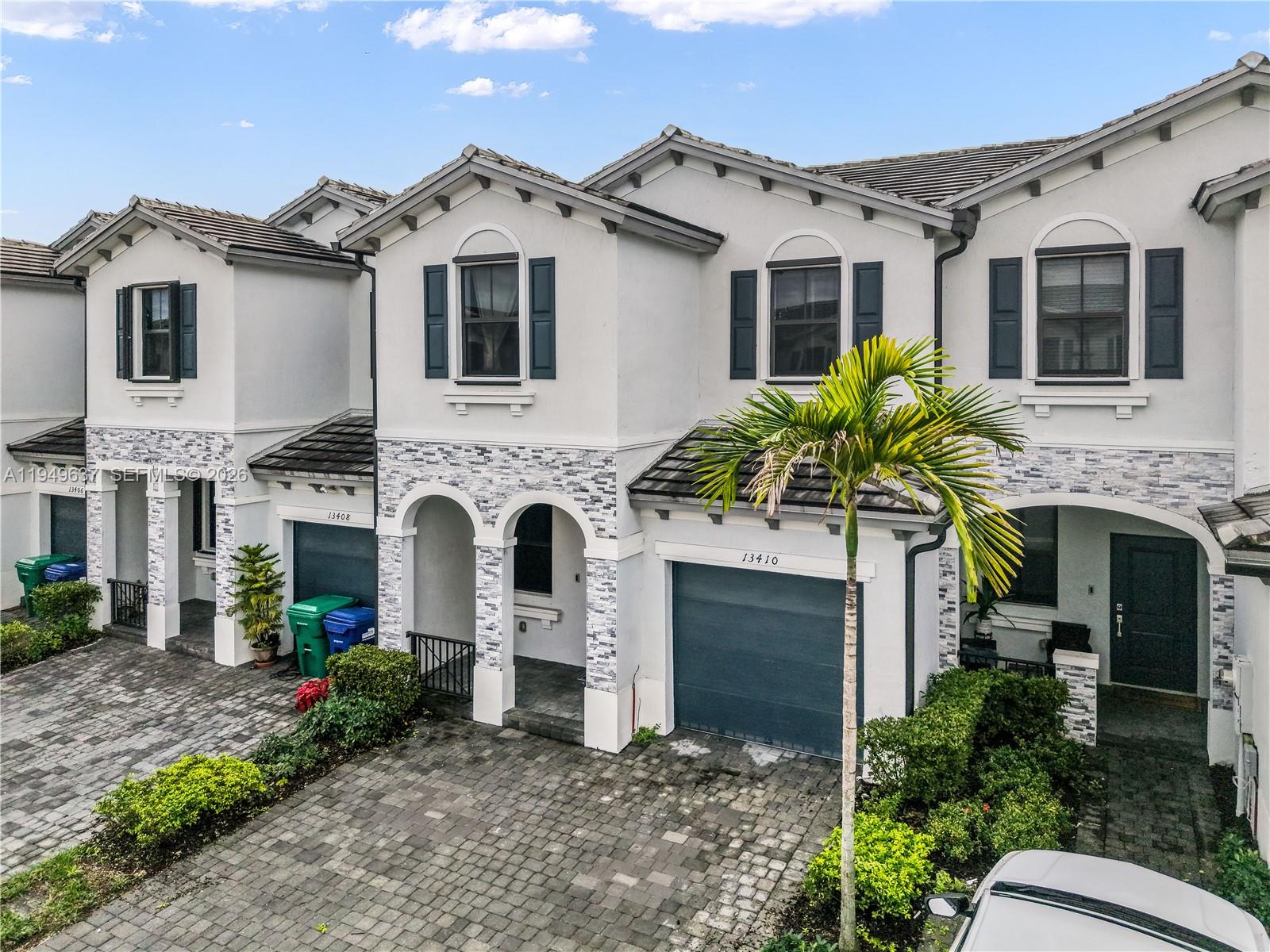 Discover modern living in this beautifully maintained 3-bedroom, 2.5-bathroom townhouse located in the desirable gated community of Pine Vista in Homestead, which is currently the fastest growing municipality in Miami-Dade County. Built in 2022, this spacious residence offers 1,827 square feet of living space under air, thoughtfully designed for comfort, functionality, and today’s lifestyle.
The open-concept main level features a bright living and dining area that flows seamlessly into the contemporary kitchen, ideal for both everyday living and entertaining. Upstairs, the generously sized bedrooms provide privacy and comfort, including a well-appointed primary suite with an en-suite bathroom with a spacious stand up shower. A convenient half bath on the main level adds extra ease for guests, while the 1-car garage offers secure parking and additional storage. Enjoy resort-style amenities right outside your door, including a gated entrance, community pool, clubhouse, exercise room, and scenic walking and biking trails. Whether you’re relaxing at home or taking advantage of the community’s recreational offerings, this townhouse delivers the perfect balance of modern convenience and active living. Centrally located near shopping, dining, and major roadways, this move-in-ready home is an excellent opportunity to own a newer construction townhouse in one of Homestead’s growing communities.