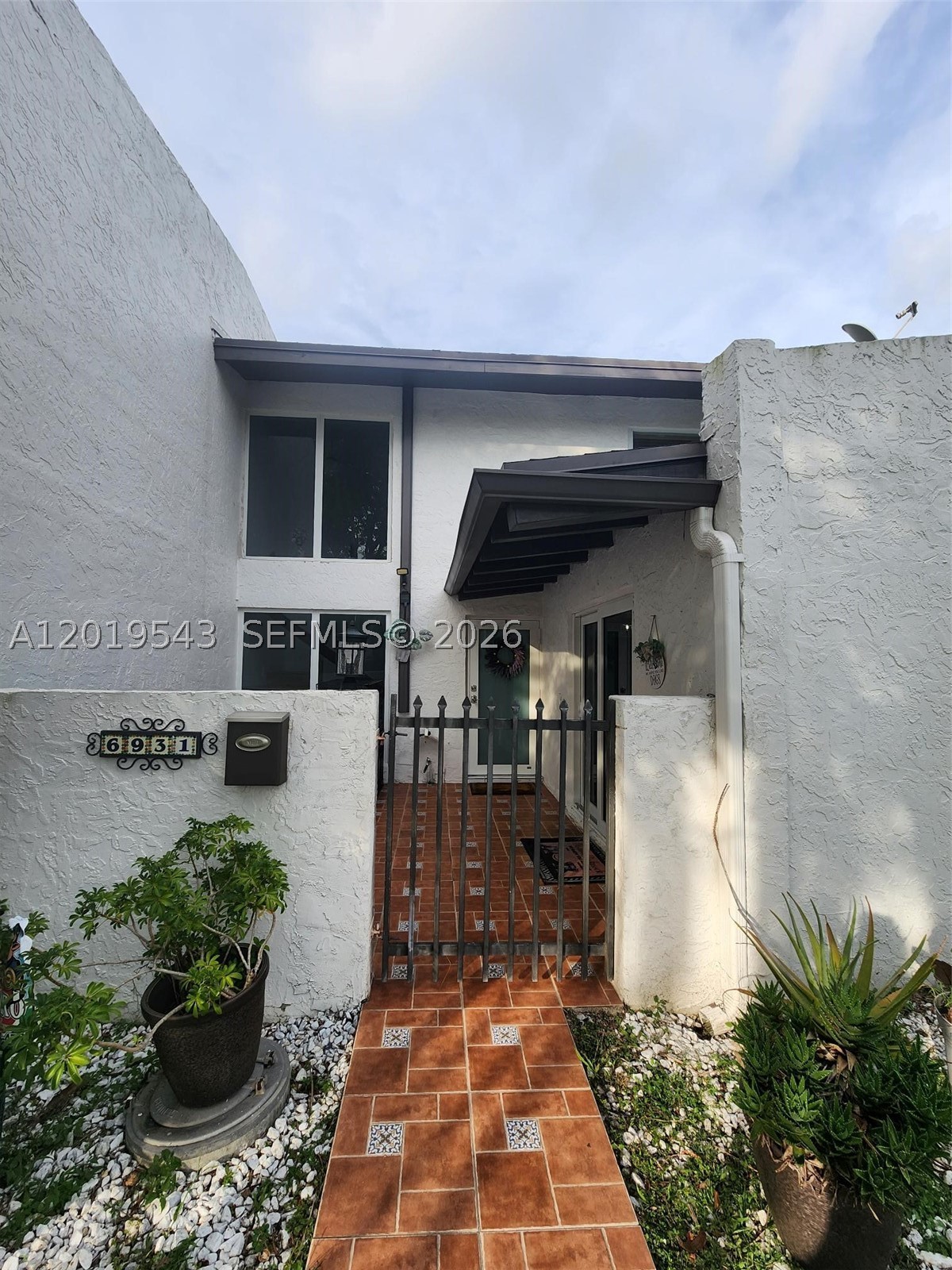 Welcome to this charming and well-maintained townhome located in the heart of Kendall! This inviting residence features major updates including a 2021 roof and impact windows and doors installed in 2022, offering peace of mind, energy efficiency, and storm protection.

Inside, you’ll find a bright and comfortable layout with newer stainless steel kitchen appliances and a convenient stackable washer and dryer. The home blends comfort and functionality with cozy living spaces and plenty of natural light.

Step outside to your private backyard retreat featuring a custom outdoor bar, stone grill, and a grandfathered-in 10x8 storage shed — perfect for entertaining, relaxing, or additional storage needs. Beyond the fence, enjoy serene pond views with direct gated access to the water, creating a peaceful outdoor setting rarely found in townhome living.

Surrounded by lush greenery and tranquil water views, this property offers the perfect combination of privacy, charm, and outdoor enjoyment while remaining close to shopping, dining, parks, and major roadways.

A true Kendall gem you won’t want to miss!