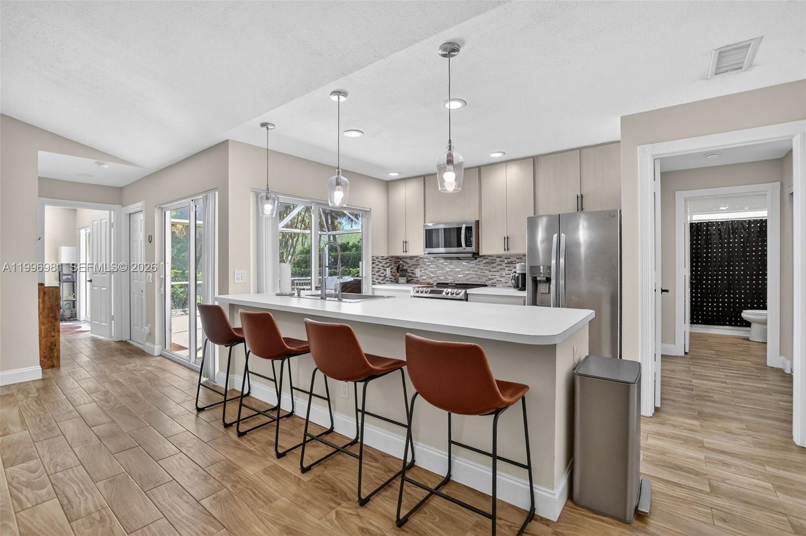 Light, bright, updated, and move-in ready villa with soaring ceilings in Lake Catherine awaits! The open concept living space is perfect for entertaining while the split floorplan offers privacy. Wood-look tile floors run continuously throughout and impact sliding glass doors offer private access to your spacious lanai from every room. No polybutylene pipes here! The association fee covers roof repairs and exterior insurance. If you are looking for a tranquil oasis in a convenient location, this one checks all of the boxes. Walkable to parks and restaurants, close to I-95 for your daily commute and a short drive to the beach for weekend relaxation.