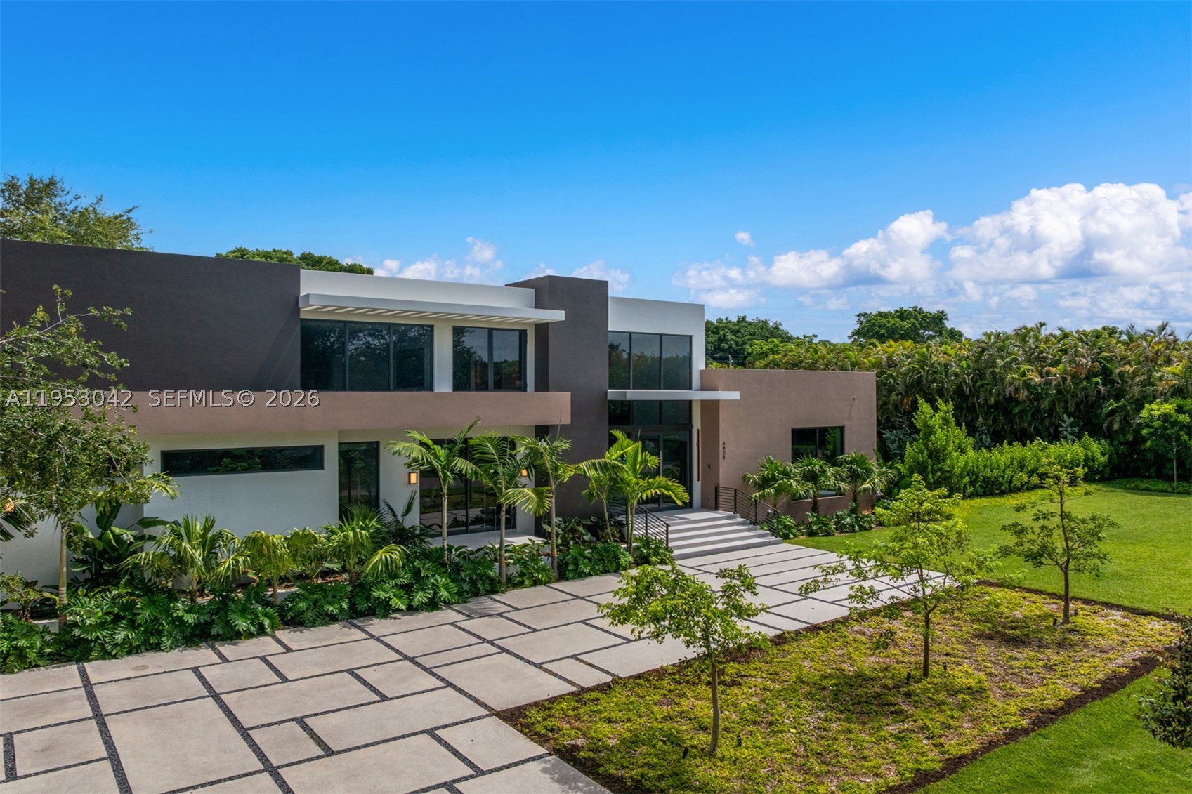 Nestled in the heart of Pinecrest, this brand-new, new construction residence is thoughtfully designed for modern luxury living and situated on an expansive builder's acre lot. Volume ceilings and floor-to-ceiling impact windows flood the open-concept interiors with natural light, creating a seamless connection between indoor and outdoor living. Offering 6 bedrooms, 7 full bathrooms, and 1 half bath, the home features elegant formal living and dining areas, a sophisticated wet bar, and a flexible room with an en-suite bath ideal as an office, gym, or playroom. The gourmet kitchen is appointed with Wolf and Sub-Zero appliances, Italian cabinetry, custom built-ins, and premium finishes throughout. Additional highlights include an elevator, Lutron lighting system, CCTV camera wiring, concrete roof, covered terraces, guest accommodations, cabana bath, and a 3-car garage. Designed for effortless entertaining, the outdoor living spaces feature a summer kitchen complete with a built-in gas grill, refrigerator, ice maker, and hood, all overlooking the resort-style pool for exceptional year-round South Florida living.