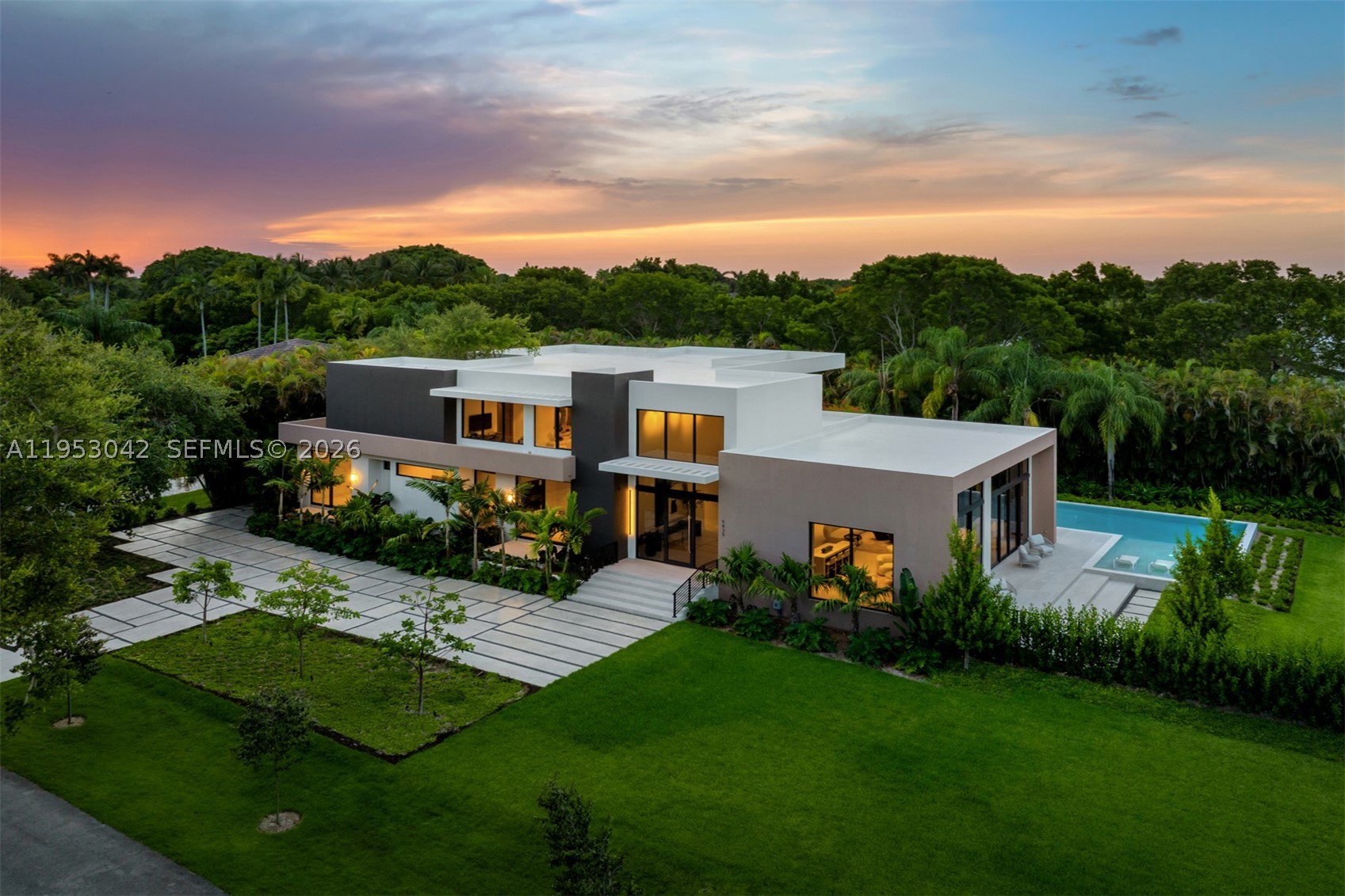 Nestled in the heart of Pinecrest, this brand-new, new construction residence is thoughtfully designed for modern luxury living and situated on an expansive builder's acre lot. Volume ceilings and floor-to-ceiling impact windows flood the open-concept interiors with natural light, creating a seamless connection between indoor and outdoor living. Offering 6 bedrooms, 7 full bathrooms, and 1 half bath, the home features elegant formal living and dining areas, a sophisticated wet bar, and a flexible room with an en-suite bath ideal as an office, gym, or playroom. The gourmet kitchen is appointed with Wolf and Sub-Zero appliances, Italian cabinetry, custom built-ins, and premium finishes throughout. Additional highlights include an elevator, Lutron lighting system, CCTV camera wiring, concrete roof, covered terraces, guest accommodations, cabana bath, and a 3-car garage. Designed for effortless entertaining, the outdoor living spaces feature a summer kitchen complete with a built-in gas grill, refrigerator, ice maker, and hood, all overlooking the resort-style pool for exceptional year-round South Florida living.